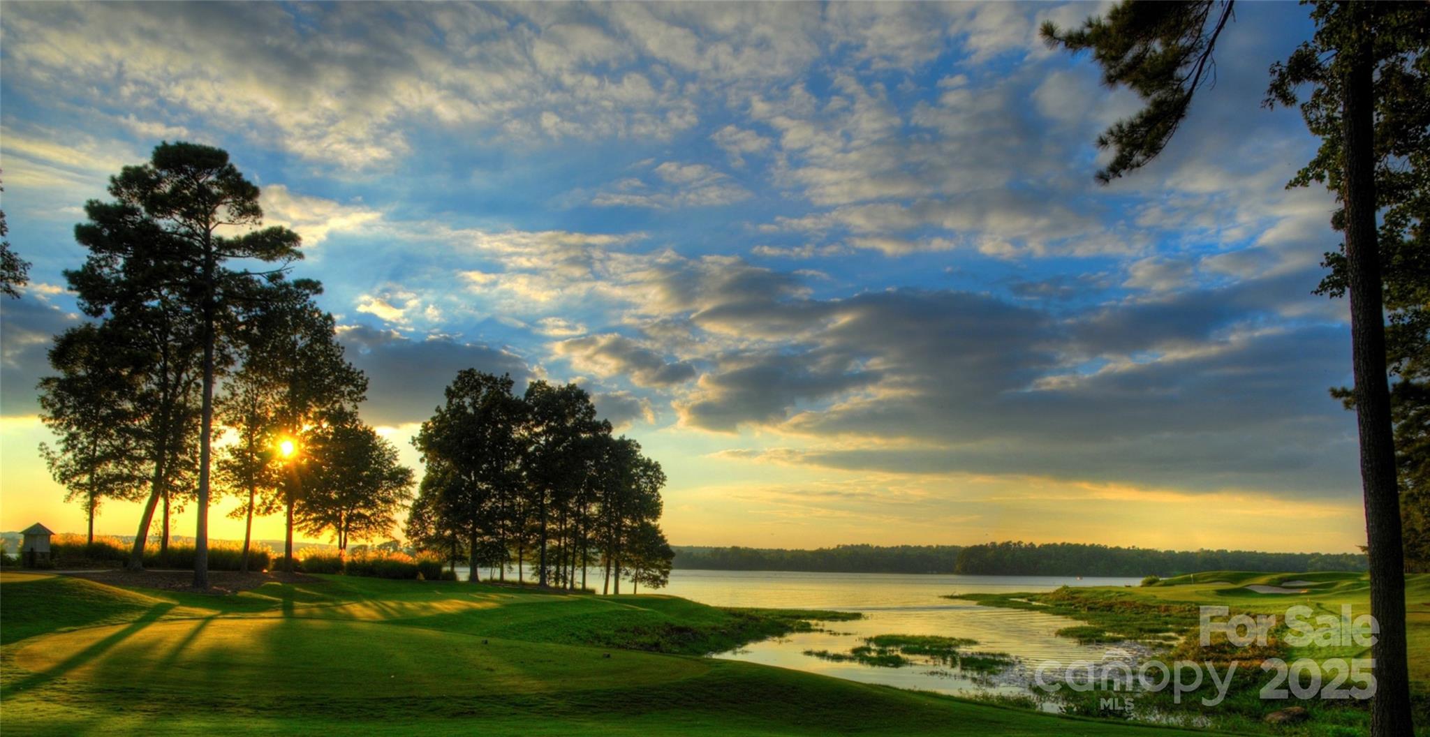 Price Improvement!  The Sunset Home Site that you have been waiting for. Frame the picturesque panoramic view, with the home of your dreams. Level, wooded with street access to public water, sewer and underground utilities. Situated overlooking Badin Lake and the Old North State 17th tee (par 3) & 16th green in the prestigious private community of Uwharrie Point.  Within walking distance of the club's amenities. This protected community is staffed with 24 hour security, golf course, marina, club house, restaurant, 2 pools, tennis courts, pickle ball, fitness, & more. The Old North State golf course is rated consistently as one of the Top 10 in N.C. Club opportunities require membership. Close enough but far enough away to Charlotte, Greensboro, Winston Salem, Raliegh and Pinehurst. Without question an opportunity with Sustaining Value.