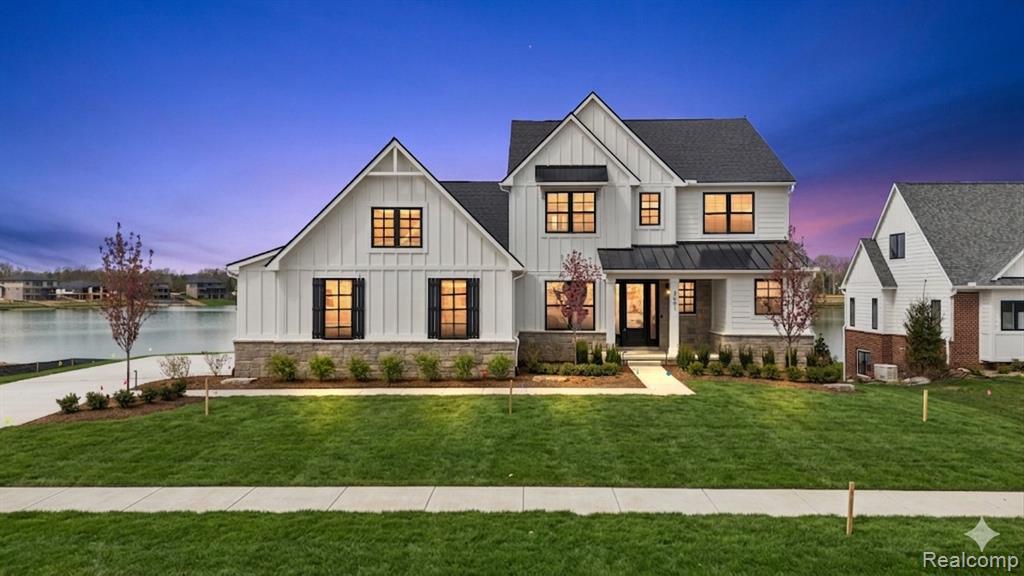 Crystal Lake is an exclusive small lake community just out side of Milford in Commerce Twp., with beautiful homes being constructed on a quiet crystal clear water feature. Robertson has designed yet another amazing floor plan that has walls of windows looking out over the lake on your own lake front homesite. This is a first floor primary suite plan with 3 additional bedrooms on the 2nd level and a finished walkout lower level which includes bedroom #5, a full bath, TV room with a centrally located fireplace, not to mention a friendly bar area where friends and family will gather. This home is currently under construction with anticipated completion summer 2026! Photos are of elevation construction drawings.