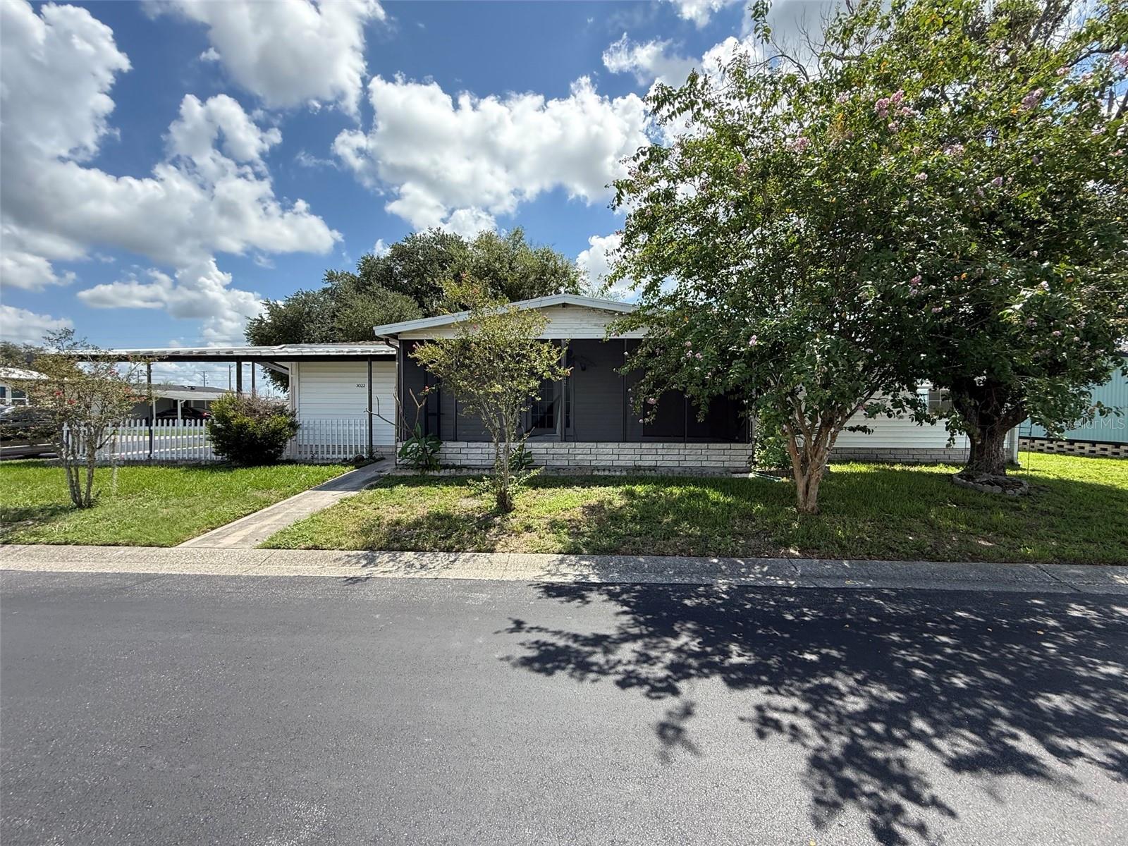 Don't miss this 3/2 in Timber Lake Estates - a gated, all ages community in Zephyrhills! Situated on a corner lot with an oversized carport and screen enclosed front porch. The interior has a living room with fireplace, kitchen with granite counter tops, laminate flooring throughout most of the home, and a primary ensuite with a walk-in closet. Community amenities include lawn care, gated access, community pools, basketball court, shuffleboard, clubhouse, and much more! This property is eligible under the Freddie Mac first look initiative through September 26, 2026.