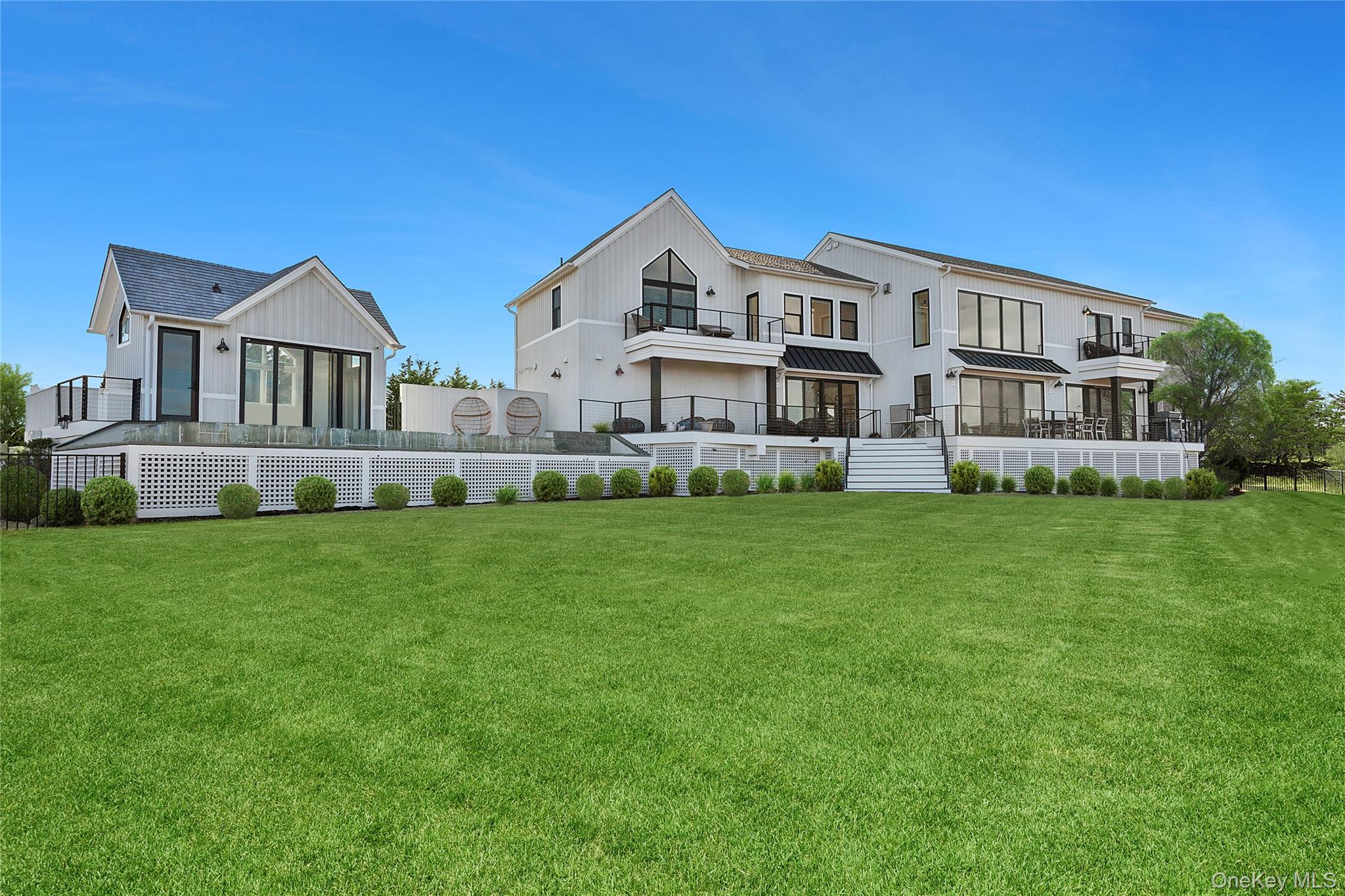 Welcome to 102 & 92 Dune Road, a uniquely designed 6,000 Square foot home, nestled in the heart of Westhampton Beach. This architectural masterpiece boasts 6 bedrooms and 6 bathrooms, each offering panoramic views of the surrounding Atlantic Ocean & Bay through expansive walls of glass. This residence offers a wealth of features that cater to modern, comfortable living with its innovative design and serene setting. Boasting a floor-to-ceiling gas fireplace, creating a warm and inviting atmosphere for relaxation or entertainment. The heart of the home is an open-concept kitchen, a pioneer design by First Dunes construction, featuring Gaggenau appliances. The main floor also offers a flexible space that could serve as a den or a junior primary suite, depending on your needs. Moving outside, the property extends its luxurious offerings with a detached pool cabana, perfect for summer gatherings or peaceful afternoons. The infinity edge heated pool, complete with a spa, offers an idyllic setting for relaxation and entertainment. Replete with private floating dock & bay access. The location of this home is second to none, with easy access to the ocean and proximity to village shops and dock, providing a perfect blend of convenience and tranquility. Welcome home where innovation meets luxury, and comfort meets style.