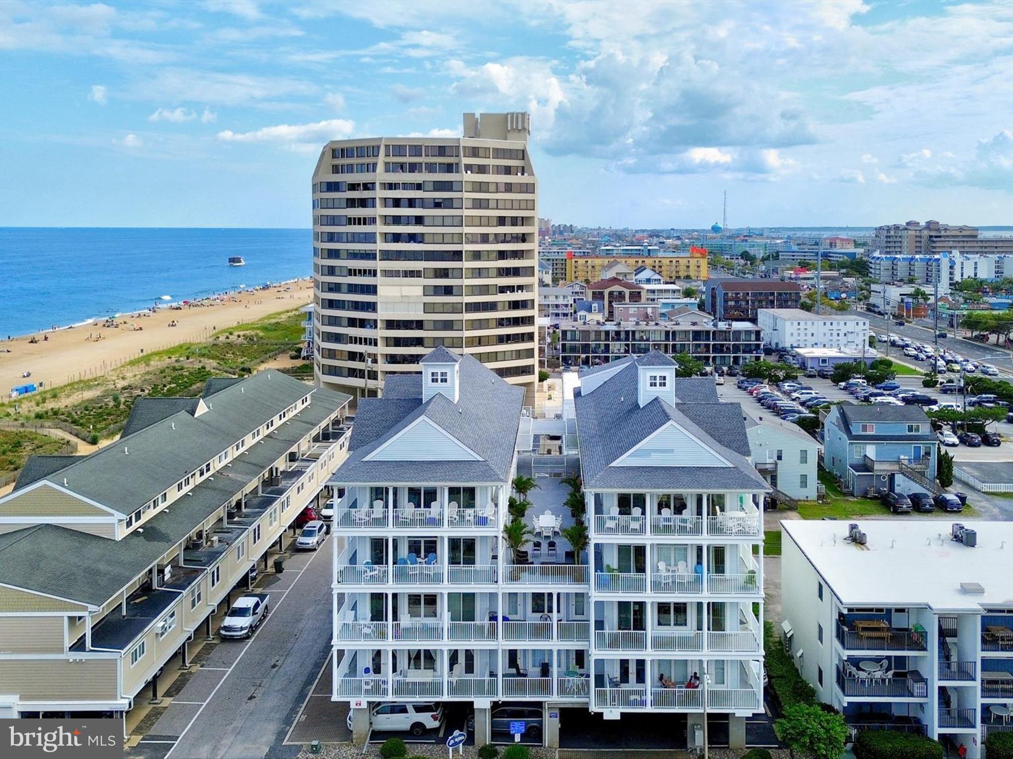 This spacious unit, just steps to the beach, has 5 bedrooms and 4.5 baths, new HVAC unit, newly replaced sliding doors, and surround sound featured in the open living areas as well as wrap around balconies with views of the beach, Atlantic Ocean & Assawoman Bay. The condo has 3 covered assigned spaces, for no hassle parking and a building elevator for ease of trips to and from the beach. "Sunrise" Unit 303, has been an occasional summer retreat for the current owners and is approximately 2622 sq. ft. and will convey with most furniture. The Gourmet kitchen features granite counters, plenteous kitchen cabinets , built in wine cooler & icemaker, the granite island conveniently offers a cooktop & vented stainless steel range hood so you can prepare a feast while socializing with your guests. The living area has aesthetically pleasing cork flooring, sliding doors and windows galore allowing an abundant of natural sunlight with views of the ocean and bay. This is an incredible offering to allow large families or great travel friends to own together in one of the most desirable garden style condo buildings in town or an incredible investment opportunity that could bring in over $100k+- in gross rental income per year.