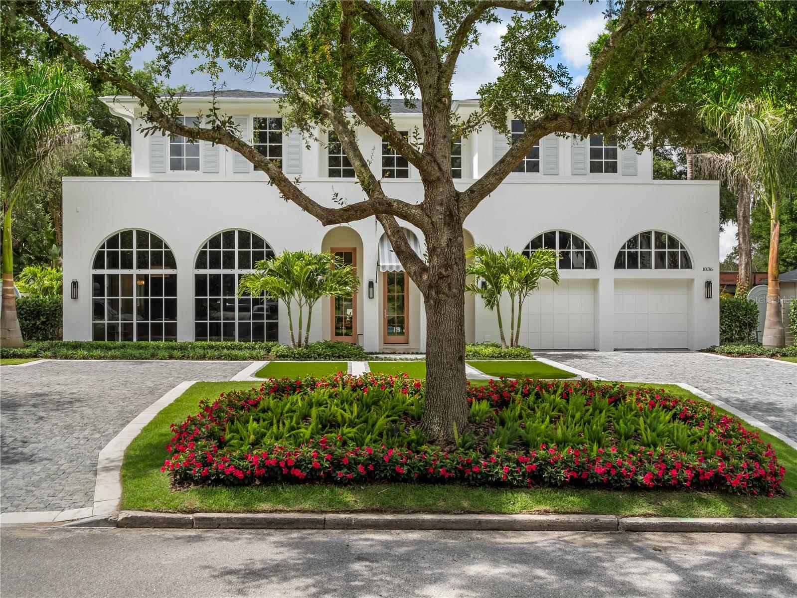 Experience resort-style living at 1836 Whitehall Drive! Inspired by the warm breeze and seaside elegance of a tranquil island paradise, this new custom home by Urban Perch, A Boutique Home Builder, offers a timeless front elevation, exquisite finishes inside and out, and unobstructed views of the beautiful outdoors from almost every room. Totaling 4,168 square feet, this five-bedroom, five-bath residence (and casita!) features a unique U-shaped floor plan ensuring natural light shines through every gathering space. Channeling the natural sands of a sunny retreat, the kitchen features white marble countertops and backsplash with blush pink undertones. A custom plaster hood, La Cornue gas range, a wall of cabinets with paneled GE Monogram appliances and a scullery with additional prep space create a kitchen ideal for entertaining. The marble island overlooks one of the main living rooms, where white oak trim highlights the precast stone surrounding the gas fireplace. A vaulted ceiling with natural wooden beams accentuates the bubble chandelier and level 5 drywall finish. Full-height sliding glass doors invite you to soak in the saltwater pool, summer kitchen, landscaped grounds and detached casita beyond. With accordion-style doors and a side entrance, the casita can serve as a pool house, personal home gym or additional bedroom with full bath. Sightlines from the main entrance lead you to the outdoors but also serve as observation points for the color-drenched first floor bedroom and primary suite with arched entry. A freestanding tub with smart glass window, zero-entry shower and extra thick Taj Mahal quartzite countertops elevate the primary bath to pure relaxation. Outside the primary suite, a concealed under-stairs laundry closet appears elegant, as impeccable millwork provides seamless transitions to the adjacent accent wall. Completing the first floor is a formal living room and dining room, a bold powder room, and a charming mudroom with custom cabinets. Follow the wrought-iron railing and engineered wood flooring to the expansive second floor. A flex room, three additional bedrooms and baths, a large laundry room, and built-in closets and benches keep everything organized and beautiful. This exceptional Winter Park home, crafted with intention and experience from award-winning local custom home builder, Urban Perch, elevates everyday living to approachable luxury.