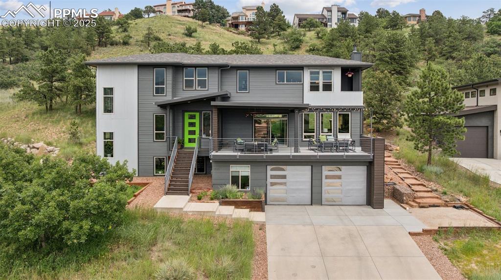 Perched in one of the most coveted locations on Colorado Springs' west side, this exceptional 6-bedroom custom residence is a masterclass in elegance, comfort, and panoramic mountain beauty. From the first light of dawn to the glow of sunset, soak in unobstructed views of the majestic Front Range and iconic Pikes Peak—framed perfectly by expansive windows throughout the home and best enjoyed from your own private rooftop patio.

Thoughtfully designed for effortless daily living and unforgettable entertaining, this home boasts a spacious, adaptable layout adorned with high-end finishes at every turn. The gourmet kitchen seamlessly flows into sun-drenched living and dining areas, creating a warm and welcoming atmosphere. Retreat to the luxurious primary suite, where a private balcony offers a serene escape and uninterrupted mountain views—a true sanctuary to start and end your day.

Outside, enjoy multiple outdoor living areas, mature trees, and the kind of privacy that’s hard to find this close to town.
Nestled in a quiet, established neighborhood with no HOA, you’ll have the freedom to truly make this home your own. All just minutes from Ute Valley Park, Old Colorado City, Garden of the Gods, and top-rated D20 schools.

Don’t miss this rare opportunity to own a view-filled custom west side gem — schedule your private tour today!