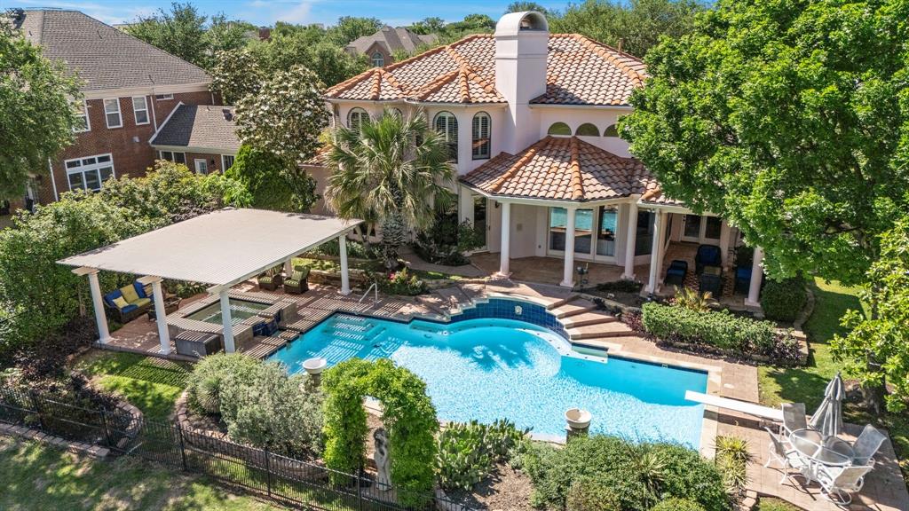 Welcome to this stunning Mediterranean-inspired retreat located in the prestigious Hackberry Creek gated community with 24.7 security guard service. Enjoy unobstructed views of the 18th fairway and tranquil water features from your own private oasis.This elegant home features fresh new paint, a stucco exterior, Saltillo tile floors, and plantation shutters throughout. The chef’s kitchen has commercial-grade appliances and enhanced with new built-in shelving in the kitchen for seamless organization. Step outside to your own backyard paradise, complete with a sparkling pool, relaxing jacuzzi, and a lush, professionally landscaped garden—perfect for entertaining or unwinding after a long day. Recent upgrades include new foam attic insulation, 2019 roof replacement, new gutter guards, a modern sprinkler system, and a new water filtration system. A spacious three-car garage adds convenience and practicality. This home offers the perfect balance of comfort, luxury, and lifestyle in one of Las Colinas most desirable gated communities.