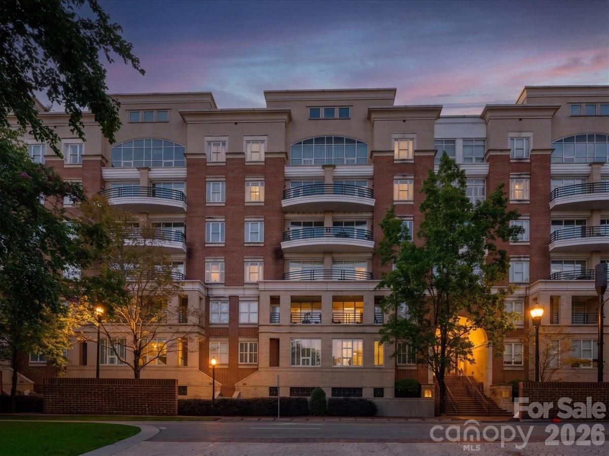 Experience the best of Uptown living in this sophisticated, townhouse-style condo community located in the heart of Charlotte’s historic Fourth Ward. Perfectly positioned within the sought-after 400 North Church building, this unit offers a combination of privacy and convenience, featuring both a secure building entrance and a private courtyard entrance, inviting seamless indoor-outdoor living. Inside, the open-concept main level is anchored by beautiful wood floors and a light-filled living, dining, and kitchen area that flows effortlessly onto a private balcony overlooking the lush courtyard. The primary suite serves as a serene retreat, offering direct balcony access, a spacious walk-in closet, and a well-appointed bathroom with dual vanities. Designed for the modern urban dweller, this home includes the essential perks of secure, deeded garage parking and an additional storage unit, while building amenities—including a fitness center and elevator access—add to the effortless lifestyle.Situated just steps from the scenic Fourth Ward Park, vibrant dining, entertainment, and the light rail, this condo captures the unique charm of a historic neighborhood while keeping you at the center of Uptown’s energy. Discover a rare opportunity to own a stylish, low-maintenance residence that balances historic character with every modern convenience.