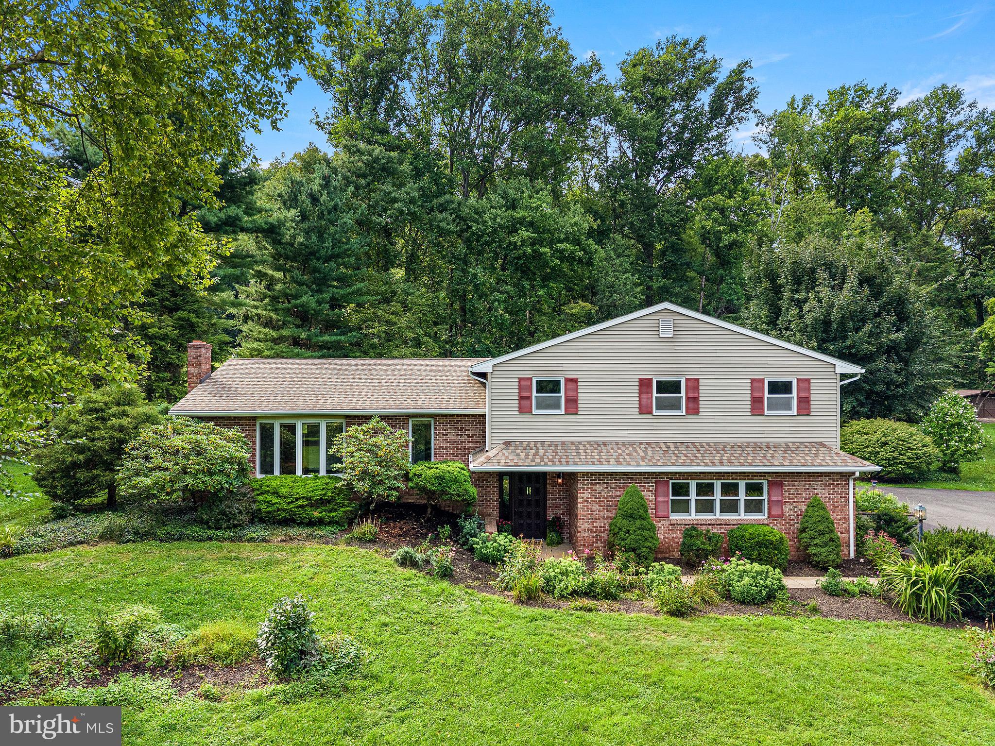 If you've been waiting for a home where the setting steals the show and the house gives you plenty of room to make it your own, this one might be calling your name. Tucked into a truly beautiful 3-acre Warwick Township property, this split-level is surrounded by scattered mature trees, established plantings, and the kind of peaceful landscape that attracts plenty of local wildlife. It feels wonderfully tucked away, yet you're just minutes from some of Chester County's best outdoor destinations, including Crow's Nest Preserve, Pennsylvania State Game Lands, French Creek State Park, Hopewell Furnace, and historic St. Peters Village less than a mile away. Hiking, fishing, kayaking, exploring, or simply disappearing into the woods for a few hours... it's all practically in your backyard.The house itself? She's a little dated, but she's got good bones, great space, and loads of potential. Bring your paint swatches, flooring choices , and imagination because there's plenty here to work with.Step inside through the tiled entry level, where you'll find a convenient laundry room, powder room, abundant closet storage, and a spacious family room complete with a wood-burning stove and sliders to an enormous covered back porch, creating the perfect spot for morning coffee, summer dinners, rainy-day lounging, or simply watching the wildlife wander through the yard.Head up a few steps to the main living level, where an oversized living room offers another wood-burning stove, a beautiful bay window for loads of natural light, and plenty of space to spread out. The kitchen features real wood cabinetry, a cozy breakfast nook, and a seriously cool built-in pantry cupboard that adds both character and storage. From the breakfast area, step directly onto the rear deck for an easy indoor-outdoor connection. A formal dining room rounds out this level and gives you plenty of room for holidays, dinner parties, or Tuesday-night takeout that somehow ends up using every dish in the house.Upstairs, the primary bedroom includes a private en-suite bath with shower stall and a generously sized walk-in closet. Three additional bedrooms share an enormous hall bathroom with laundry chute - and when we say enormous, we mean there's plenty of space to rethink and reimagine it into something special.An attached two-car garage handles the everyday parking and storage, while two additional storage sheds give you even more room for garden tools, outdoor gear, hobbies, and all the things that seem to multiply once you own some land.Located in Chester County, within the Owen J. Roberts School District, this is a property for the buyer who appreciates space, privacy, mature landscaping, an incredible natural setting, and a location surrounded by some of the area’s most beautiful preserved lands. If you are looking to create a home that's every bit as special as the land around it, your journey starts here.