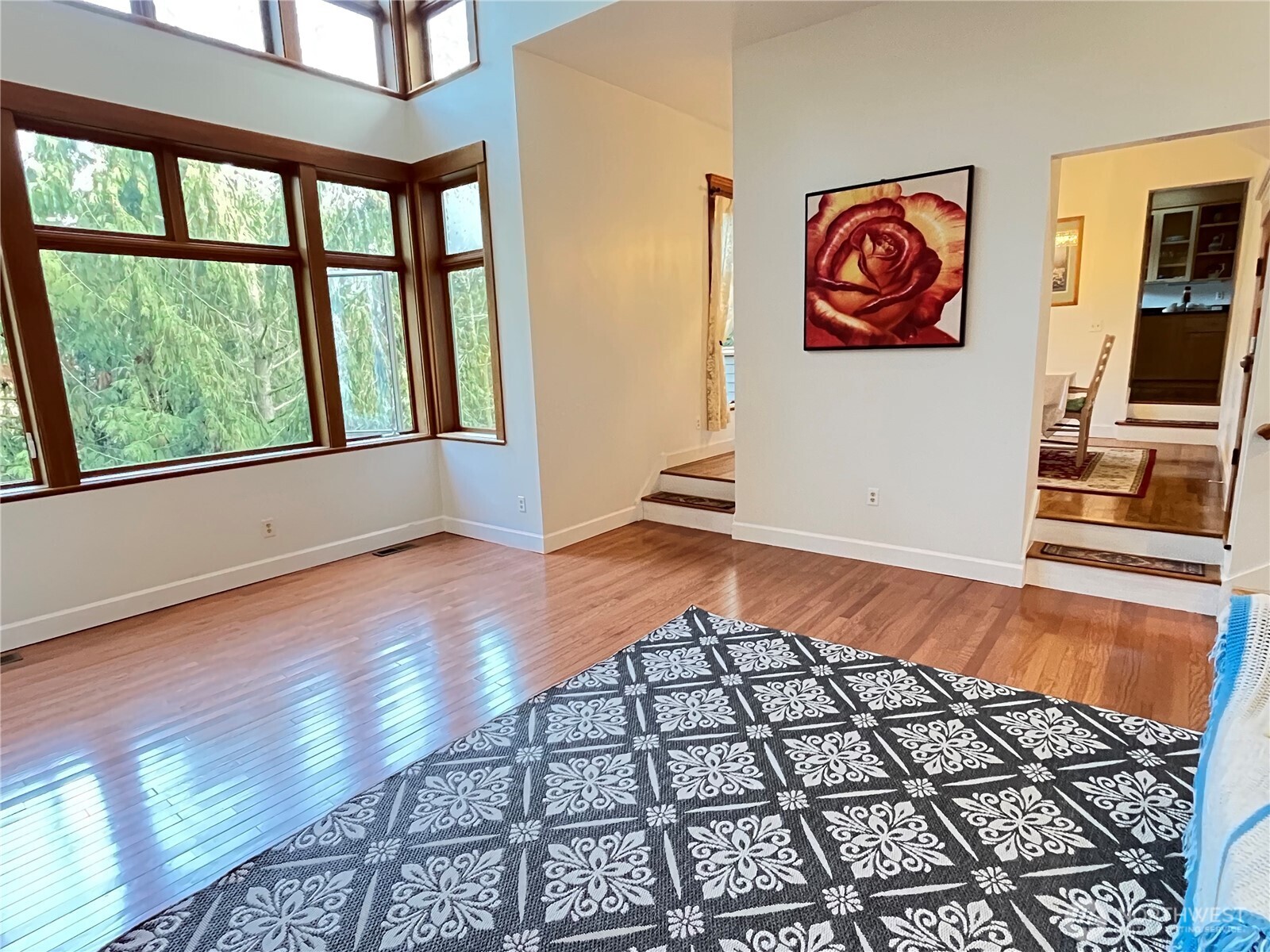 Beautifully private and surrounded by nature, this spacious home sits on a quiet, flat street with lush greenbelt privacy. Enjoy low-maintenance living and a sunny, oversized deck with treetop views. The light-filled kitchen and great room offer extensive granite counters and a large pantry. A 600 sq. ft. finished basement provides flexible space for a media room, gym, office, or play area. Upstairs features a generous primary suite, three additional large bedrooms, 2.5 baths, and a convenient laundry room. Skylights brighten the home throughout, and ample storage adds easy organization. Centrally located near top schools, parks, the library, and the Amazon Shuttle stop.