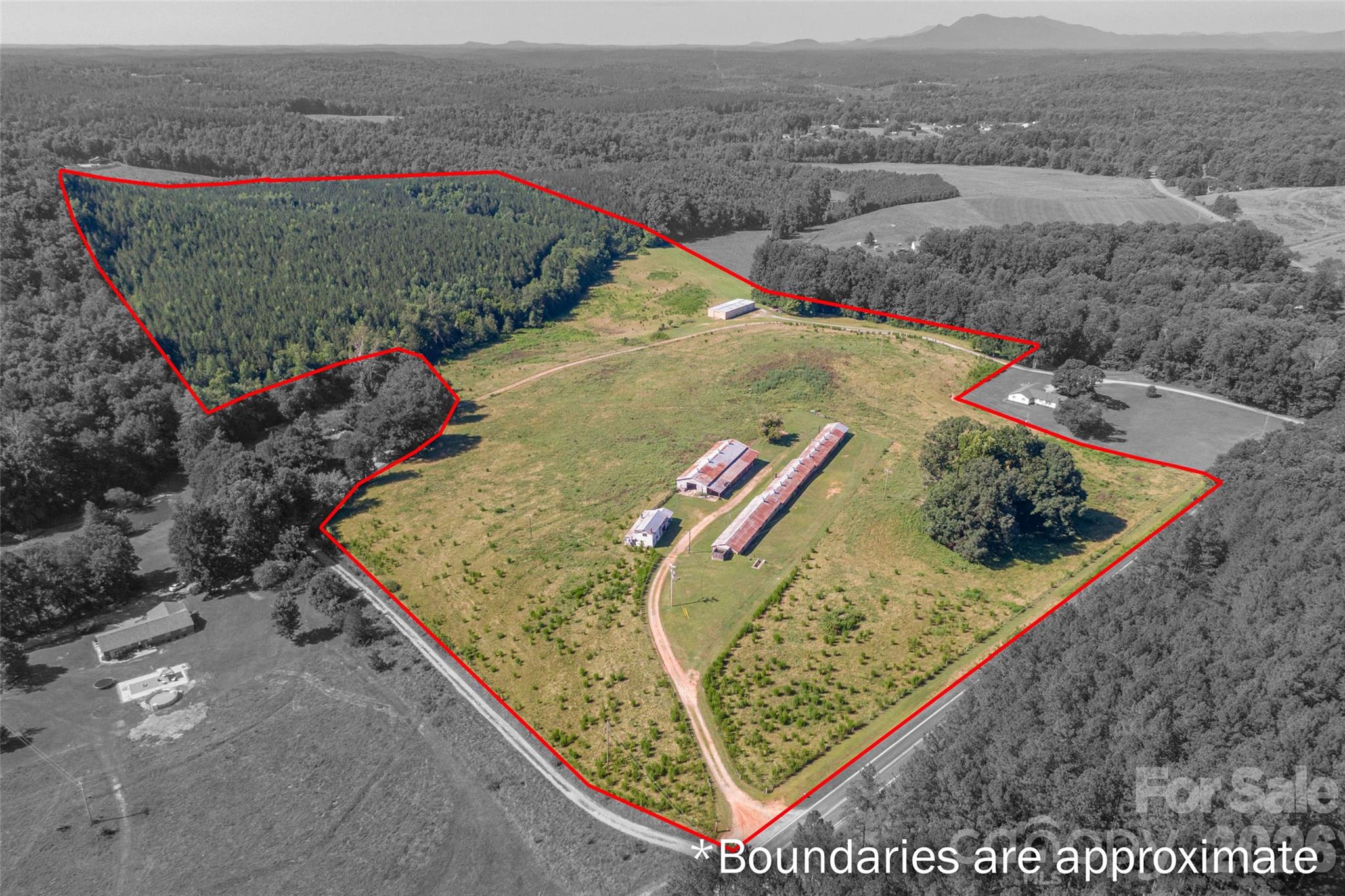 Nestled in the foothills of Rutherfordton, North Carolina, this land on Pleasant Grove Road offers approximately 83 acres of unrestricted opportunity—an exceptional canvas for your vision. The land is rich in natural beauty, featuring a clear, meandering creek that brings life and tranquility as it winds through the property. Beyond the creek, a wooded hillside rises gently, where selective clearing could reveal inspiring mountain views and create a dramatic setting for a dream home, event space, or private retreat.This farm is overflowing with potential for agricultural, recreational, or entrepreneurial pursuits. A substantial 40x100 (approx. 4,000 sq. ft.) workshop—complete with an office, three-phase power, and an air compressor that conveys—stands ready to support a wide range of uses. Several barns, sheds, and three 24x110 former poultry houses offer flexible infrastructure for farming, storage, or repurposing into new ventures. The property also includes a cattle barn, and while the farm buildings will need some repairs, they can be restored or cleared to suit your plans. The pasture is currently used for cattle, but livestock will be removed prior to closing.Previously operated as both a poultry farm and a working cattle farm, this land holds the foundation for a productive agricultural operation or a private legacy estate. Its blend of natural features and practical assets makes it a rare investment—one that can nurture dreams, growth, and new beginnings for years to come.3 acres and the home (621 Pleasant Grove Rd) will be surveyed out of the parent tract unless the buyer would like to purchase for an additional $100,000. The remaining portion of the property will be approximately 83 acres as described in this listing.