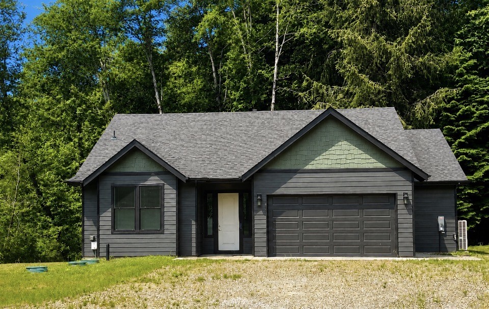 Almost-new 3-bedroom, 2 bath home on 5 private acres along the river! This exceptional riverfront property offers the perfect blend of comfort, space & lifestyle. Inside, soaring vaulted ceilings & luxury vinyl plank flooring flow throughout, creating a bright, open feel. The kitchen shines with quartz countertops, stainless steel appliances & a seamless connection to the great room. A cozy wood stove efficiently heats the home, adding warmth & charm. Step outside to the expansive covered deck overlooking the river the ideal spot for morning coffee or evening unwinding. And for the hobbyist or mechanic? A massive 30x60 shop/garage completes the package. Move-in ready & waiting for you.