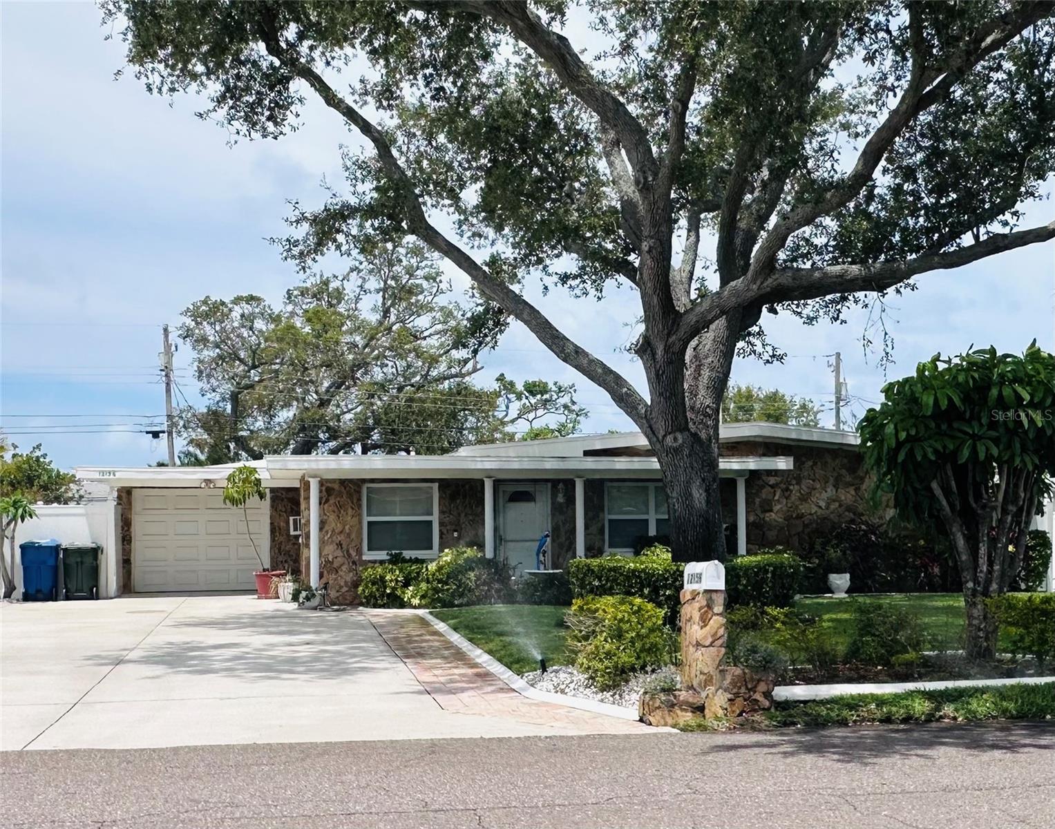 Under contract-accepting backup offers. Location, Location, Location .....  Welcome to this beautifully maintained, one-owner block home located less than one mile from the beach! Situated in a non-evacuation area with no flood insurance required, this property offers peace of mind along with an exceptional coastal lifestyle.  The home features 2 cozy bedrooms and 2 full baths, with a bright, white kitchen showcasing granite countertops and crisp cabinetry that create an inviting, timeless look. The living area is anchored by a wood-burning fireplace, adding warmth and character.  A true standout feature is the expansive 948-square-foot tandem garage, offering endless possibilities for multiple vehicles, a workshop, storage, or recreational equipment. Pride of ownership is evident throughout, with the home having been meticulously cared for by its original owner.Whether you’re seeking a primary residence, vacation retreat, or investment opportunity close to the Gulf, this well-maintained home delivers comfort, functionality, and an unbeatable location near the beach.