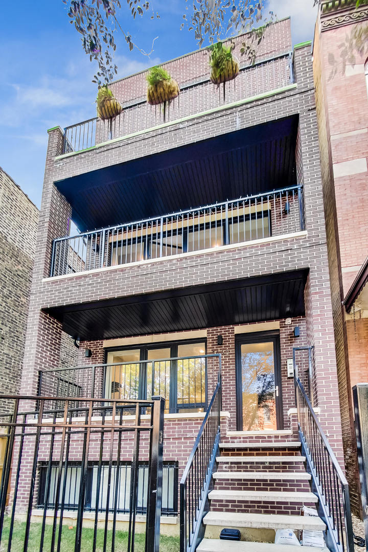 Massive 4BD/3.1BA duplex down in an all-brick 2019 construction, offering nearly new interiors, modern finishes, and the rare opportunity to be the home's 2nd resident. Step inside to abundant natural light, 5" wide white oak floors, and fresh paint throughout-perfectly suited for both living and formal dining. The chef's eat-in kitchen showcases sleek, contemporary design with custom Italian cabinetry, quartz countertops, marble backsplash, and premium stainless steel appliances. Adjacent, a warm and inviting family room features beamed ceilings and a cozy fireplace. All four bedrooms are thoughtfully placed on the lower level, including a gracious primary suite with walk-in closet and spa-like en suite bath complete with heated floors, oversized shower, and double vanity. Three additional bedrooms are generously sized with ample closet space. Enjoy three private outdoor retreats, including a rooftop deck with Trex, pergola, and garden space. Steps from Humboldt Park, the 606, dining, transportation & more!