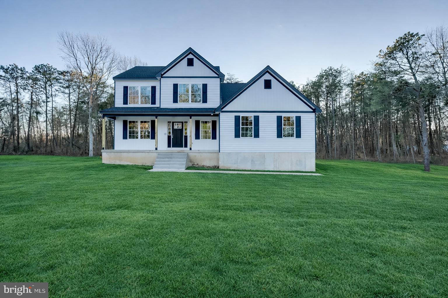 NEW, NEW, NEW—A Rare Opportunity in Gloucester Township!Welcome to this exceptional brand-new construction home, perfectly positioned on over 1.5 acres of serene land in the heart of Gloucester Township. Offering the ideal blend of modern design, thoughtful layout, and peaceful surroundings, this 4-bedroom, 2.5-bath residence delivers everything today’s buyers are searching for be it space, quality craftsmanship, and long-term peace of mind with brand-new systems, appliances, and warranties.A welcoming covered front porch sets the tone as you enter through an insulated front door with elegant glass sidelights, flooding the interior with natural light. Inside, you’re greeted by a spacious formal living room and dining room, both enhanced by luxury vinyl plank flooring that flows seamlessly throughout the main level, creating warmth, durability, and visual continuity. Bathrooms on the main floor feature ceramic tile flooring for both style and function. One of the home’s most desirable features is the main-floor primary bedroom, offering ultimate convenience and flexibility, ideal for multigenerational living or anyone seeking minimal stair use. The heart of the home is the stunning, oversized kitchen, designed to impress and perform. It showcases Craftsman-style cabinetry extending to the ceiling, beautifully accented with thick white crown molding, a timeless subway tile backsplash, and sleek black granite countertops. A large center island with seating overhang provides the perfect space for casual dining and entertaining. Also highlighted by a stylish designer light fixture above. The deep sink with an elegant arched faucet is perfectly placed beneath a window overlooking the backyard, adding both charm and functionality. Completing this chef-inspired space are gas cooking, top-of-the-line stainless steel appliances, and a generously sized pantry to keep everything organized and within reach. Attention to detail continues throughout the home with two-panel interior doors, abundant recessed lighting, and a bright, airy atmosphere in every room. A sliding glass door off the kitchen leads to the expansive rear yard, offering seamless indoor/outdoor living. Just off the kitchen, the family room provides a comfortable and inviting space to relax, unwind after a long day, or gather with family and friends, perfect for making lifelong memories. The primary suite is a true retreat, generously sized and finished with luxury vinyl plank flooring, recessed lighting, and a ceiling fan for year-round comfort. The adjoining spa-like primary bathroom is nothing short of impressive, featuring a corner soaking tub framed by two windows, a dual white vanity with ample cabinetry, bold black fixtures, and rich black granite countertops. The stall shower showcases cultured marble-style ceramic tile, a built-in black granite seat, and a dramatic black-tiled shower floor that creates a striking, upscale aesthetic. The hall bathroom continues the home’s elevated design with antiqued bronze fixtures, a white dual vanity, classic gray subway tile tub surround, and octagon honeycomb-patterned ceramic tile flooring. Three additional bedrooms offer plush carpeting, ceiling fans, recessed lighting, and generous closet space, ensuring comfort for everyone. The laundry room is thoughtfully designed with ample space and coordinating honeycomb ceramic tile flooring, making everyday tasks both convenient and stylish. Outside, the property truly shines, offering ample parking, vast outdoor space, and a rear yard that backs to wooded surroundings, delivering the privacy and tranquility so many buyers desire. Whether you envision outdoor entertaining, gardening, or simply enjoying the peaceful setting, this property provides endless possibilities. This home offers the rare combination of brand-new construction, premium finishes, expansive land, and a prime location. Don’t miss your chance to own a truly special property! Schedule your tour today!