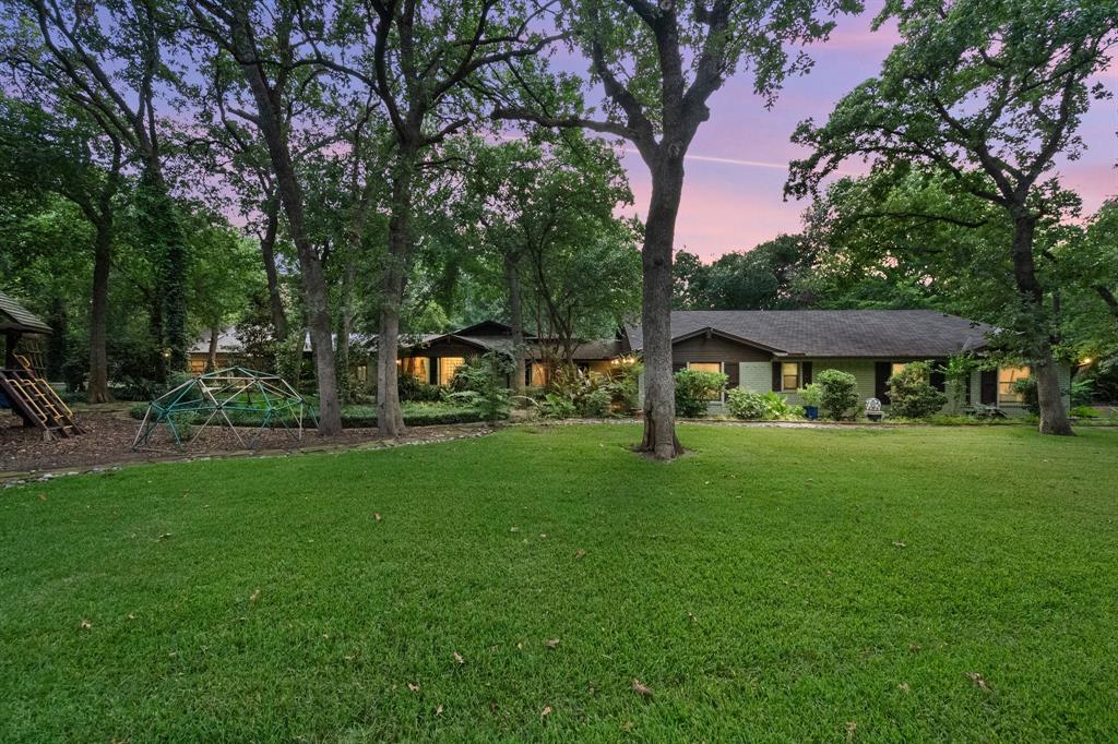 DISCOVER LUXURY LIVING RE-DEFINED on this spectacular 3 acre estate that seamlessly combines metropolitan convenience with countryside tranquility. This remarkable 5 bedroom, 5 bathroom residence offers over 4,600 square ft of thoughtfully designed living space.  The heart of this home showcases knotty pine tongue & groove ceilings & dramatic windows that flood the interior with natural light. A chef-inspired kitchen flows effortlessly into the stunning living area, anchored in the dining room by an impressive fireplace. The private office with separate entrance and dedicated half bath provides an ideal professional sanctuary. The expansive living area offers views of the outdoor pool and lush gardens and is wired for sound.  The primary bedroom suite delivers a spa-like retreat featuring a 6 ft soaking tub, elegant pebble stone shower, and an expansive walk-in closet with built in dresser. The primary suite opens easily to the pool area and has views of the creek & gardens. A custom 1,000 sq ft addition completed in 2020 adds 3 generous bedrooms and a versatile flex room, perfect for hobbies, guests, or multigenerational living.  Step outside to your personal oasis with a sparkling pool and oversized deck complete with an easily accessible pool bath.  The professionally landscaped grounds feature a peaceful creek surrounded by local wildlife, .75 miles of walking trails that wind throughout the estate and a self maintained state of the art Wifi Irrigation system with water conserving capabilities.  The impressive 7 car garage with sleek roller doors will delight automotive enthusiasts and includes a tandem garage with drive through access.  Perfectly positioned just minutes from major highways, the airport, and highly-rated schools, this exceptional property offers the rare combination of secluded luxury and urban accessibility. Some photos are virtually staged.