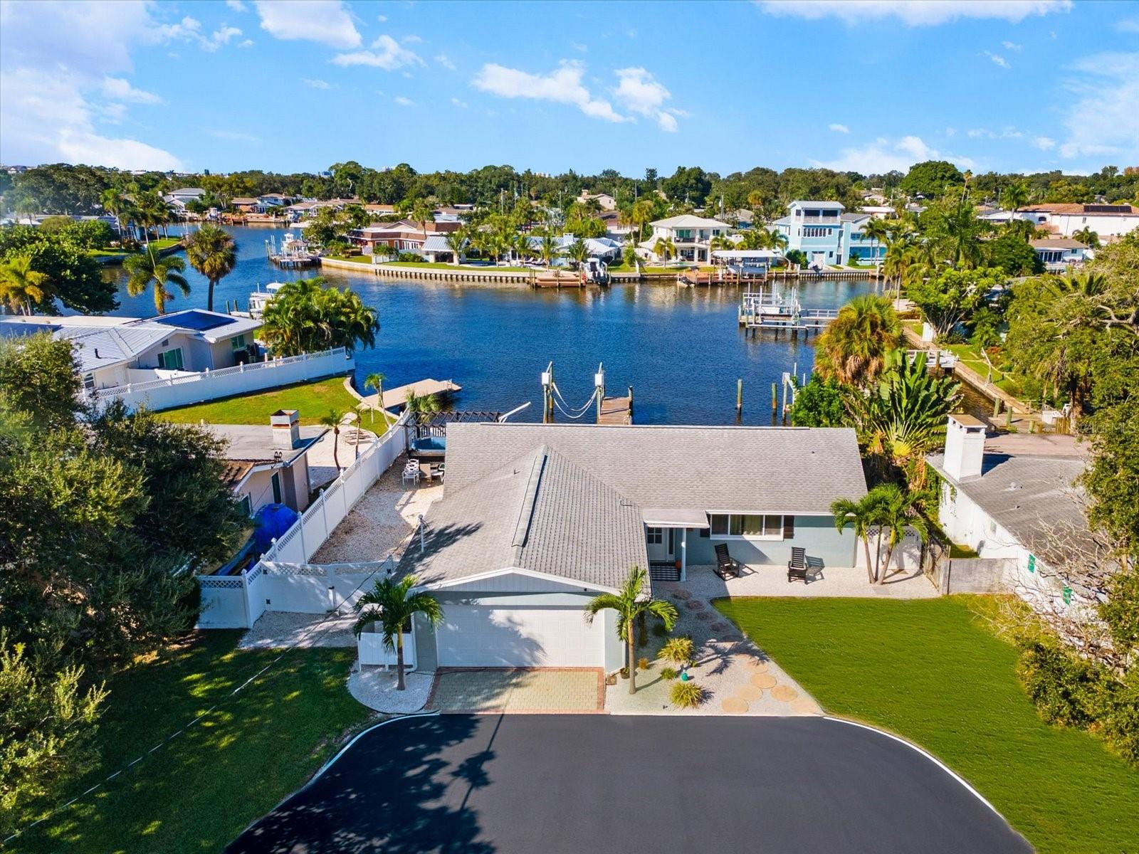 Welcome to this completely updated waterfront retreat, ideally situated on a quiet dead-end cul-de-sac with no through traffic! Featuring 3 bedrooms, 2 bathrooms, and breathtaking 180-degree unobstructed water views, this home offers the perfect blend of coastal living, modern updates, and outdoor enjoyment. From the moment you step inside, a stunning wall of impact-rated sliding glass doors showcases 77 feet of protected waterfront frontage and brings the beauty of the water right into your living space. Enjoy fishing from your private dock while watching manatees, dolphins, and other local wildlife in their natural habitat. Boating enthusiasts will appreciate the deep-water access and easy route to the Gulf of America, along with a private dock featuring water and electric, a 10,000-pound boat lift, and a fenced seawall for added peace of mind. The home has been thoughtfully updated with new flooring, cabinets, countertops, light fixtures, and more, plus all-new impact-rated glass and storm shutters for added protection. The desirable split-bedroom floor plan offers privacy, while the air-conditioned laundry room adds everyday convenience. A versatile bonus room overlooking the water provides the perfect space for a potential fourth bedroom, formal dining room, playroom, or home office. Outside, enjoy a huge side yard with RV parking and hookup, plus plenty of room to add a pool and create your own private backyard oasis. Located in the highly regarded Anona Elementary school zone, this property also offers convenient access to local restaurants, shopping, and some of America's most beautiful beaches. Whether you're looking for a full-time residence or a waterfront escape, this exceptional property delivers the best of Florida living!