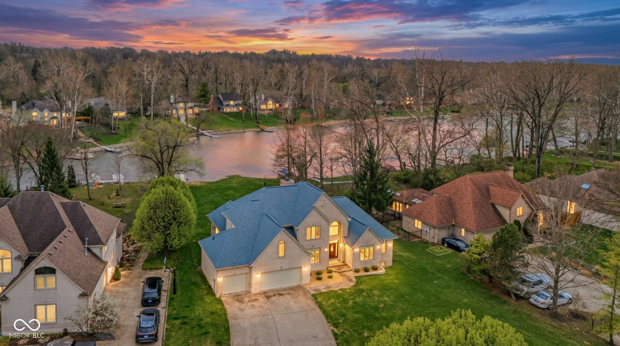 Welcome to 5717 Fall Creek Road-where resort-style living meets everyday convenience, just minutes from the best of the city and the suburbs.  Set on a tranquil waterfront lot, this fully reimagined 4/5 bedroom home with 4.5 bathrooms delivers a private retreat experience with a brand-new floating dock, expansive composite deck, and a stunning three-season room-perfect for morning coffee, sunset views, and effortless entertaining.    Step inside to a grand, light-filled foyer featuring refinished maple hardwoods, a striking crystal chandelier, and an open-concept design built for both elevated living and connection. The designer kitchen is a true centerpiece, showcasing Calcutta quartz countertops, premium Monogram appliances, induction cooktop, and sleek European finishes-where style meets performance.    The main-level primary suite is a serene escape, offering peaceful water views, private deck access, dual custom walk-in closets, and a spa-inspired ensuite with frameless glass shower and luxury fixtures. Upstairs, a second primary suite and airy loft provide flexible, high-end living for guests or multi-generational needs.    The finished lower level expands your lifestyle even further-complete with space for a home theater, gym with spa-like bath, office, and entertaining area, all finished with premium touches.  Extensive upgrades-including a new 50-year roof, Pella windows, enhanced insulation, modern mechanicals, and whole-home systems-deliver comfort, efficiency, and peace of mind.     A heated three-car garage, advanced security, and included luxury features make this a rare, truly turnkey opportunity.  Live like you're on vacation-every single day.