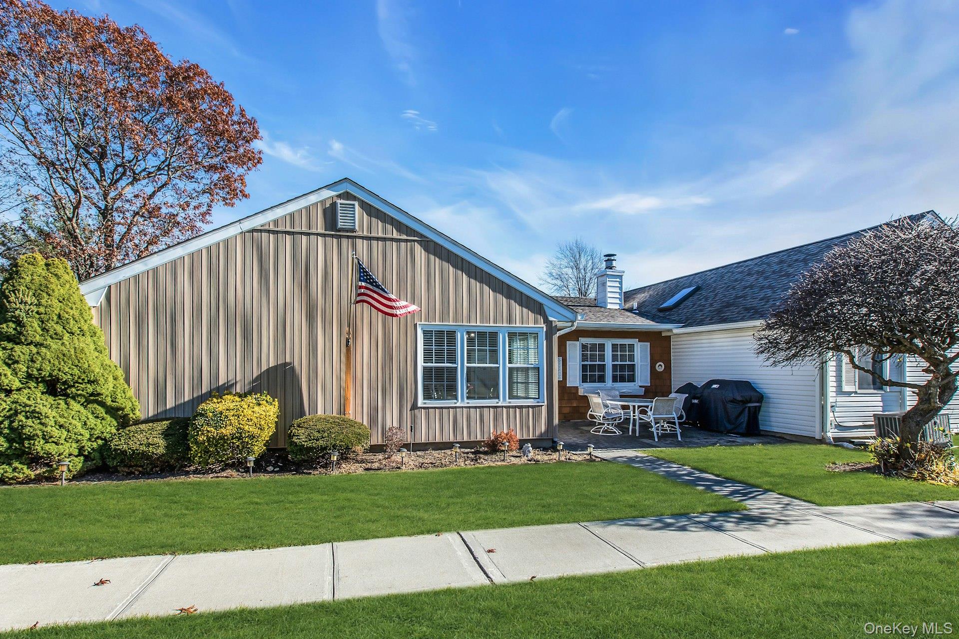 Welcome to This Nicely Updated One Level, Ranch Style Home in Sayville's Own, Vibrant and Highly Sought After, Sunrise Village 55+ Gated Condominium Community. This Spacious Dartmouth Model Offers 2 Bedrooms and 2 Full Baths. Beauty Along with the Ease of Low Maintenance.  Bright, Open Corner End Unit Looks Out to Center Courtyard, Gazebo and Lush Landscaping. Walls Freshly Painted with Neutral Hues Await Your Personal Touch.  Luxury Vinyl Plank Flooring Flows Throughout From the Entry, to the Eat In Kitchen, Living Room, Dining Room, Hallways and Bedrooms. Custom Blinds Add a Beautiful Touch to the Oversized Living Room that Flows Into the Dining Room. Features of the Spacious Primary Bedroom Include: A Beautifully Appointed Primary Bath Updated with Designer Vanity, Gleaming Tile and Walk-In Shower, Along with Dual Closets, One Being A Large Walk In with High End Closet Organizer. The Roomy 2nd Bedroom, Smartly Located at the Other End of the Home, Offers Privacy and Options for use as 2nd Bedroom, Office or Den.  It Conveniently Sits Near to the Updated Full 2nd Bath.  Down the Hallway, as you walk Toward the Interior Entrance to the Private, Full Sized Garage, Sits the Oversized Laundry Room, Providing Additional Storage with Room for Pantry, Craft area or Workspace. You'll find the Outer Entrance to the Garage off the Rear Courtyard. Garage has Electric Door Opener, Space for Work Area and Storage Attic Access with Pull Down Stairs. Additional Updates Include, CAC (2021), Separate Hot Water Heater (2021)   The Sunrise Village Community Offers many amenities along with Community Pool, Clubhouse and Fitness Center.   Move right in, sit back and relax!  Welcome Home!