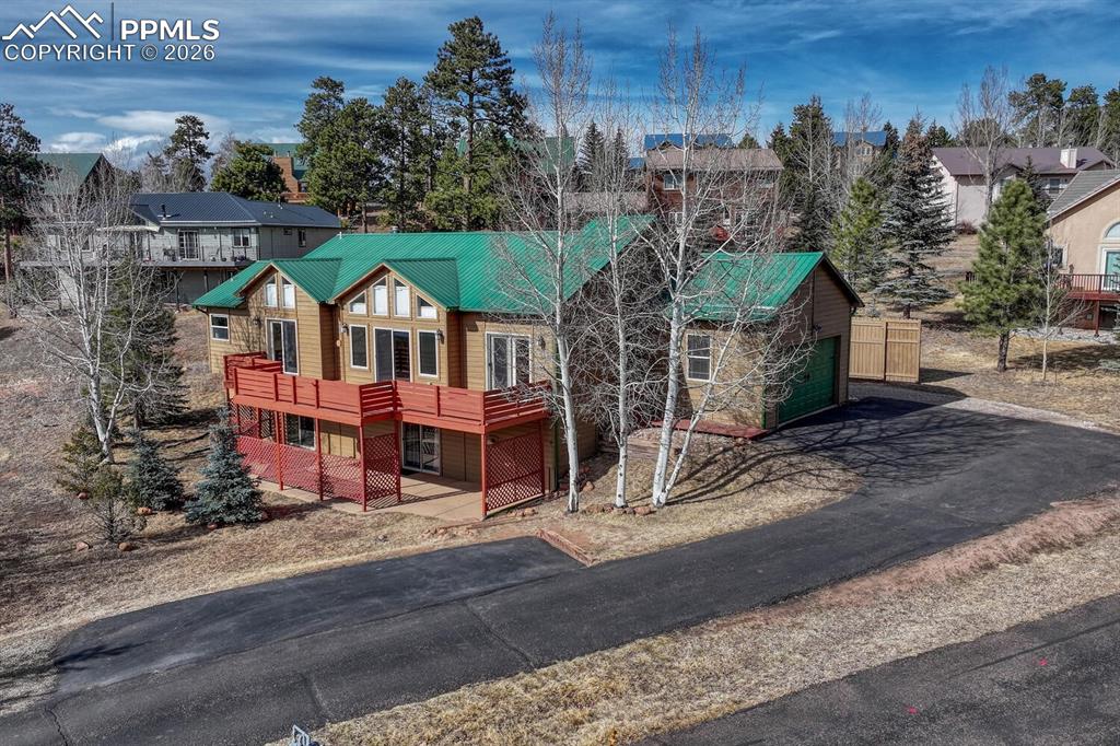 Nestled in a breathtaking mountain setting, this beautiful Woodland Park retreat offers the perfect blend of space, comfort, and unforgettable views. Set on a large lot surrounded by aspens and evergreens, this home delivers the peaceful Colorado lifestyle you’ve been searching for — with room to breathe, explore, and relax.Step inside to soaring vaulted ceilings and a light-filled great room framed by expansive windows showcasing big mountain views. The open main level is warm and inviting, centered around a cozy gas fireplace — perfect for crisp mountain evenings. The updated kitchen features ample cabinetry, modern appliances, and a functional layout that flows seamlessly into the dining area, ideal for everyday living or entertaining.One of the true highlights is the huge deck stretching across the back of the home, offering the perfect place to grill, gather with friends, or simply soak in the sweeping scenery and fresh alpine air.The spacious primary suite provides a relaxing retreat with plenty of room and comfort. Downstairs, a large basement family room offers flexible additional living space and features a second gas fireplace, creating the perfect spot for movie nights, guests, or a quiet lounge area.With RV parking, generous outdoor space, and an unbeatable mountain backdrop, this property is ideal as a full-time residence, second home, or Colorado getaway. Enjoy privacy, views, and the best of Woodland Park living — just minutes from town amenities, hiking, and endless outdoor adventure.Schedule your private showing today and experience mountain living at its finest!