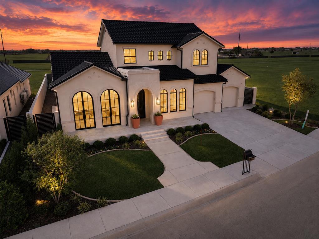 Experience luxury lakefront living in THE VILLAS at ASHTON GROVE...Norman's premier community offering easy luxury living with picturesque lakes, serene walking paths, and gated entries. This exquisite home boasts over 3,400 square feet of thoughtfully designed living space, set on a prime .25-acre lake view lot with an oversized garage. From the oversized arched windows to the tile roof, this home epitomizes quality and craftsmanship. The   primary suite overlooks the breathtaking lake views through huge arched windows and allows access to the front terrace to take in the panoramic views. The luxurious primary bathroom sets the mood for calm and tranquility. The expansive great room seamlessly flows into a covered outdoor living area, creating the perfect space for entertaining or unwinding while overlooking the backyard which offers plenty of space for a custom pool or water feature. The great room is versatile living and dining spaces boasting a cast stone enhanced fireplace. The front living/study takes in the lake views and is versatile to fit your lifestyle. The chef’s kitchen is a true masterpiece, equipped with top-of-the-line appliances, a huge island, and a generous butler’s pantry. Upstairs, a spacious media/flex room boasts a wood paneled wall and wood floors. The third bedroom is upstairs and features lake views and a full bathroom. There is also a large walk-in storage room. The garage is oversized and offers even more storage. This thoughtfully designed residence combines versatility and comfort with modern elegance. Every detail reflects quality craftsmanship and timeless design from the soaring ceilings, hardwood floors, designer lighting, custom cabinetry, premium finishes and expansive windows that fill the home with natural light while framing picturesque views!  Experience easy luxury living at its finest in Ashton Grove! Conveniently located in NW Norman.