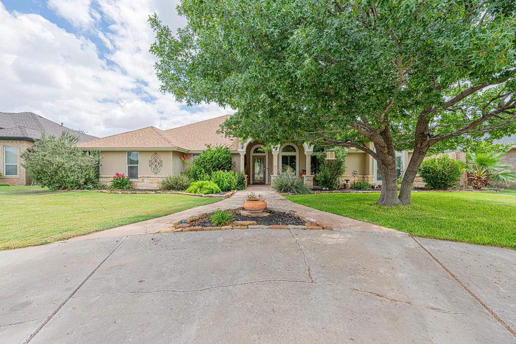 Unbeatable location! This open-concept home features recent wood-look tile, an updated kitchen with plenty of cabinet space, and a living room with coffered ceilings and crown molding. The versatile sunroom with a mini-split is perfect for a gym, man-cave, hobby, or dog room. Unmatched storage and parking with a 3-car garage, golf-cart carport, and heavily floored attic! Mature trees, large front/back porches, and a heated pool add to the outdoor living experience. Virtual tour available.