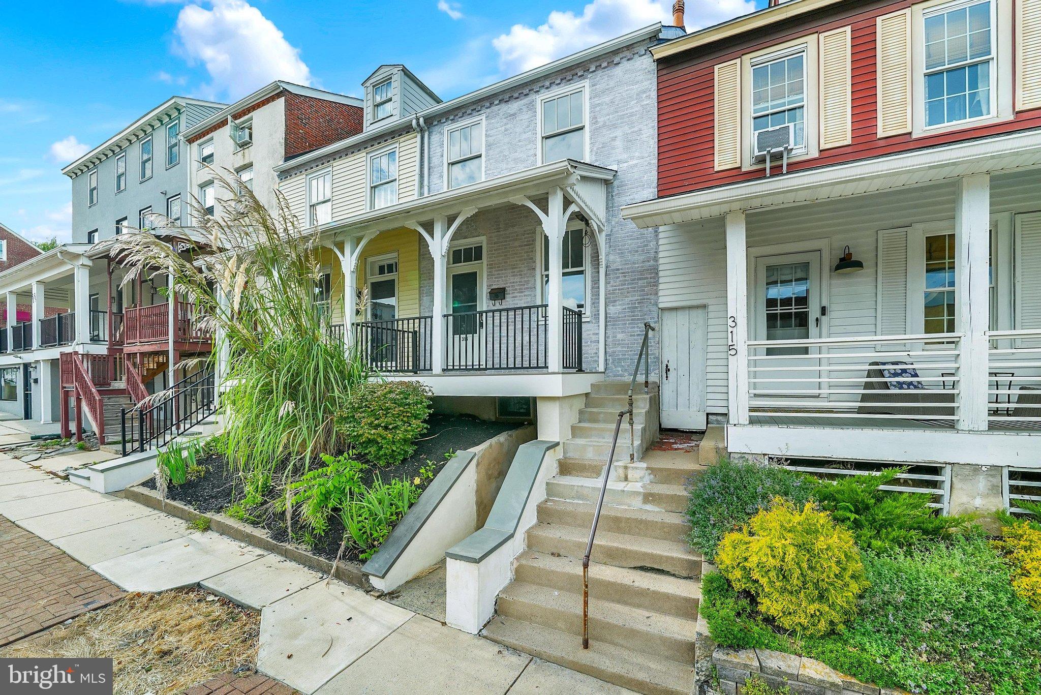 Welcome to 313 E State Street, an inviting end-of-row home that combines downtown convenience with exceptional value in the heart of Kennett Square. Situated right along the main avenue, you are just a short walk from local boutiques and top dining spots like Talula’s Table, Trattoria La Tavola, Sweet Amelia's, and La Michoacana Ice Cream. The Kennett Area YMCA and the trail-lined greenery of Anson B. Nixon Park are also just around the corner.Ascend the front steps to a raised, covered front porch—the perfect setting to enjoy your morning coffee while taking in the neighborhood energy. Inside, brand-new carpet flows through a bright living room anchored by a decorative brick fireplace with a glass enclosure. Classic decorative columns frame the entrance to a formal dining room, which leads straight into a functional galley kitchen. Outfitted with durable vinyl plank flooring, stainless steel appliances (including a gas range), and space for a small dining table, the kitchen opens directly to a private, fenced rear yard with dedicated off-street parking accessible via E Maple Street.The second floor features plush new carpeting across two comfortable bedrooms—including the primary bedroom and a quaint second bedroom—alongside a full hall bathroom with vinyl plank flooring and a classic tub/shower combination. Up on the third floor, you will find two unique, character-rich bonus spaces with new carpet underfoot. The rear-facing room includes a bright window and a window-mounted A/C unit, making it ideal for a cozy third bedroom, creative studio, or private home office. The interior front room is windowless and tucked away, offering a clever setup for a walk-in dressing room, quiet study nook, or organized home storage space.Down in the unfinished basement, you will find the home's gas heating system, utilities, laundry area with washer and dryer included, and handy walk-out access directly to State Street. Move-in ready, attractively priced, and perfectly positioned for vibrant, walkable town living, this home offers incredible potential in a location that cannot be beaten.