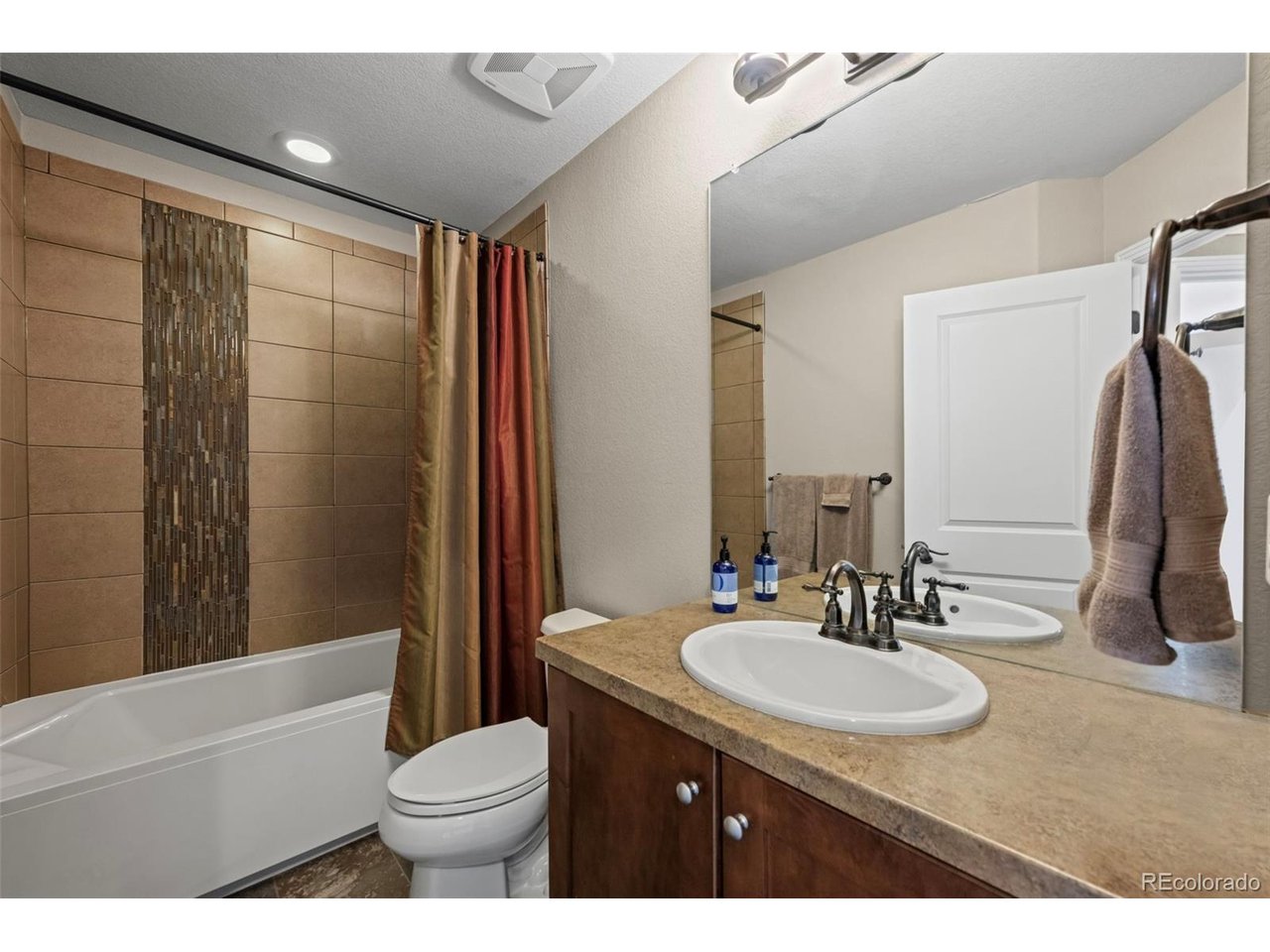 GREAT NEW PRICE! Located in one of Louisville's most desirable pockets-and arguably one of the best locations in Steel Ranch South-this former model townhome offers a beautiful blend of space, comfort, mountain views and easy Colorado living. With over 2,300 square feet, 2 bedrooms, 2.5 baths, and an attached two-car garage, there's plenty of room to live and entertain. Step inside from the slate entry and you're immediately welcomed by dramatic cathedral ceilings and a beautifully upgraded spaced flooded with natural light. This model features the largest kitchen plan, offering abundant storage, a walk-in pantry, and generous counter space. The kitchen is a true standout, complete with quartz countertops, soft close drawers and roll outs, a custom copper backsplash, stainless steel appliances, and a large center island-opening seamlessly to the dining and main living areas for a connected, inviting feel. Additional upgrades include theater lighting, custom stair railings, surround sound speakers, air filtration system and tankless water heater. Upstairs, the primary suite offers a comfortable retreat with vaulted ceilings, a private bath, generous closet space and adjacent laundry room. The second bedroom enjoys great light and views, with plenty of room for guests or family, while the loft provides flexible space for a home office or reading area-and could easily be converted to a third bedroom. The lower level and attached two-car garage provide additional storage and functionality, and the overall layout offers that sought-after single-family feel with the ease of townhome living. Set within a quiet, well-maintained community built in 2013, this home is ideally located with easy access to trails and open space, as well as all that makes Louisville so special - from local dining and shops to Main Street, nearby parks, and recreation. Convenient access to both Boulder and Denver completes the package.