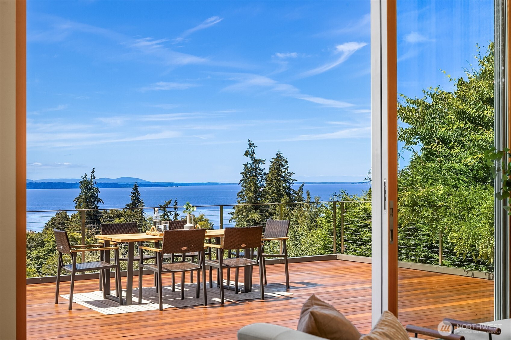 Skyward windows and soaring walls of glass capture sweeping West-facing vistas of Puget Sound and the Olympic Mountains, creating a stunning backdrop from nearly every room. Privately gated and nestled on a beautifully landscaped 1/2 are in Edmonds' coveted Meadowdale, this extensively updated Northwest contemporary offers exceptional privacy, modern luxury, and effortless indoor-outdoor connection to its extraordinary setting. Thoughtfully designed for both grand entertaining and everyday living, the home is filled with natural light and seamlessly transitions to a series of remarkable outdoor spaces. Premium LaCantina doors open to a spectacular Ipe hardwood deck and heated covered patio, blurring the line between indoors and out while showcasing unforgettable sunsets and panoramic water-and-mountain views year-round. Luxurious primary suite, a tranquil retreat featuring new windows and a beautifully remodeled spa-inspired bath. Updated guest accommodations and fully renovated bathrooms reflect the same attention to comfort and design found throughout the home. Recent improvements include a new heat pump with air conditioning, backup generator, remodeled lower-level living areas, refreshed kitchen cabinetry, extensive landscaping and terraced grounds, automated driveway gate, security system, and more. Rarely does a home of this caliber become available.