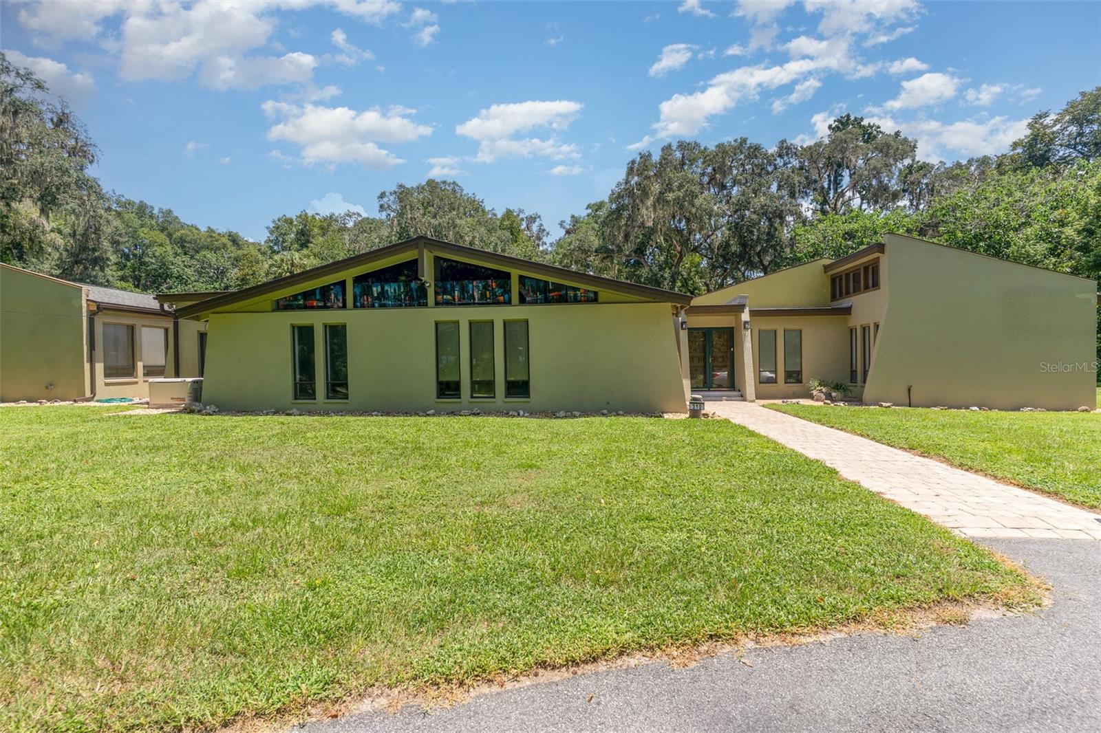 Luxury, Privacy & Versatility on 2.59 Acres in Ocala’s Sherwood Hills

Welcome to 310 SW 35th Street — a private, park-like retreat surrounded by majestic oak, hickory, and pine trees, offering timeless beauty and year-round shade. This impressive estate features a 4-bedroom, 3.5-bath main home plus a garage apartment with private entrance and full bath, perfect for multi-generational living or guest accommodations.

Step inside and discover a home designed for both comfort and style. The spacious family room and dining room showcase stunning tongue-and-groove cathedral ceilings, creating a warm, inviting atmosphere. Walls of glass open to serene views of the sparkling pool and paver patio, flooding the living areas with natural light. The gourmet kitchen boasts a large center island, granite countertops, breakfast bar, dual pantries, and both casual and formal dining spaces—perfect for gatherings big or small. The split floor plan includes a luxurious primary suite with spa-style bath, two guest bedrooms connected by a Jack-and-Jill bath, and a fourth bedroom with its own ensuite.

The garage apartment is a fully self-contained living space with its own entrance—ideal for extended family, visiting friends, or even potential rental income.

Outdoors, the in-ground pool is your private oasis, surrounded by a fenced patio for relaxation and entertaining. The 2.59-acre property offers plenty of open space, with mature trees providing shade, privacy, and a connection to nature. A whole-house generator ensures uninterrupted comfort and peace of mind, and there’s no HOA to limit your vision for the property.

Additional highlights include a two-car garage, well and septic system, updated roof and exterior paint (2021), HVAC (2020), and select interior updates in recent years.

Perfectly located just minutes from downtown Ocala and the World Equestrian Center, this estate blends luxury, practicality, and natural beauty in one remarkable package. Whether you’re relaxing by the pool, hosting guests, or enjoying the shaded grounds, this home is designed for the lifestyle you deserve.

Schedule your private tour today and experience the perfect balance of elegance, comfort, and nature.