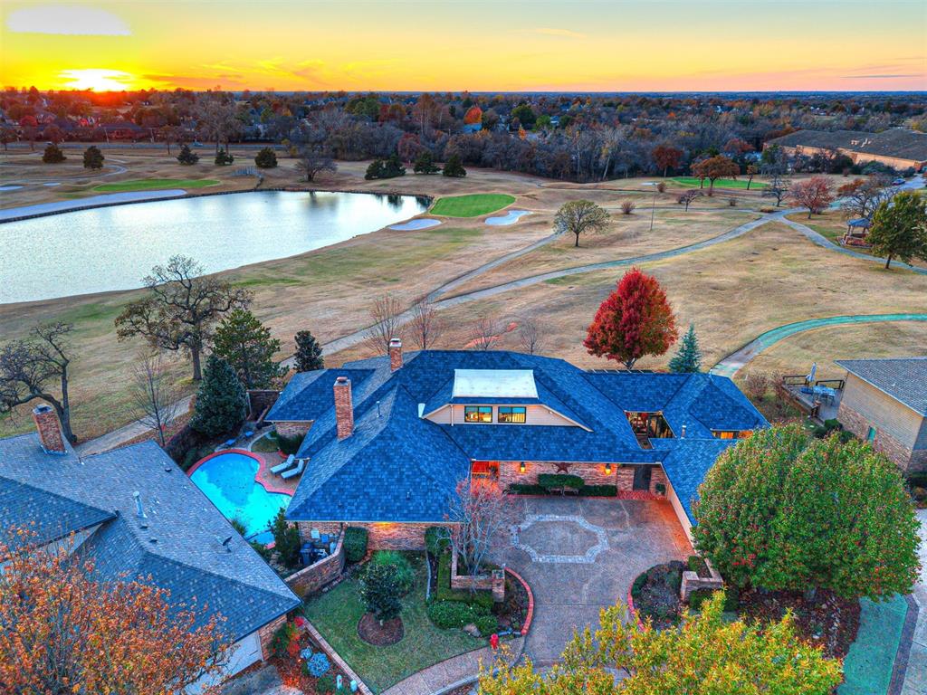 Welcome to a truly exceptional residence within the gated Oak Place enclave of Oak Tree Country Club, one of Edmond’s premiere golf course communities. This home offers a rare blend of elegance, space, and lifestyle — a dream retreat for those who value luxury living and entertaining.Inside, you’ll find a flexible floor plan with an upstairs that can function as either a bonus room or a bedroom. Both the bonus room and the study have en suite bathrooms, in addition to the other two bedrooms having en suite full baths.  The primary suite is a show-stopper: a large bedroom with a cozy fireplace, plus an oversized spa-style bath, and direct views of the private pool.Entertaining will feel effortless with two separate living areas and a massive chef-worthy kitchen that opens to the home’s heart. The kitchen has everything a culinary enthusiast could want — ample counter and cabinet space, a layout designed for cooking and entertaining alike, and a flow that connects with the living and dining zones.Step outside to the huge back deck and you’re greeted with breathtaking views of the manicured golf course, serene pond, and incredible Oklahoma sunsets — a setting rarely rivaled in Edmond. The private pool adds another dimension of resort-style living, creating a peaceful oasis right in your backyard.Positioned inside a guarded, gated community known for its championship golf course, country club amenities, and serene setting, this home offers not just a place to live — but a lifestyle many aspire to. It stands out as one of the most special homes in Oak Tree, especially for anyone drawn to golf, privacy, and elevated living.