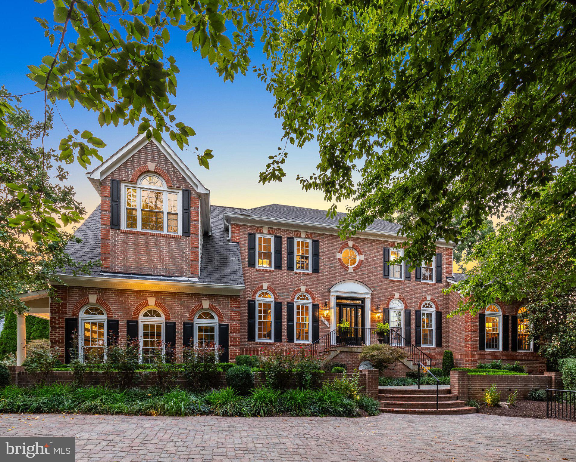 Dream yard.  Dream home. The kind of place where everyone wants to gather. Set on just over an acre at the end of a quiet cul-de-sac, this stately three-sided brick colonial combines estate-scale living with the warmth and comfort of a true family home. A long paver driveway sweeps into a circular drive, creating an impressive introduction to more than 6,600 finished square feet.Beautiful wood entry door opens to a dramatic two-story foyer framed by gracious formal living and dining rooms. Rich hardwood floors and expansive windows carry throughout the main level. The sunroom, spacious enough for a grand piano, is filled with natural light and opens to the wraparound deck. A private office with built-in bookshelves provides a handsome place to work, while the soaring two-story family room centers around a gas fireplace flanked by windows.An extensive renovation created a chef’s kitchen designed for serious cooking and effortless entertaining. Two Sub-Zero refrigerators, two Miele dishwashers, a Wolf gas cooktop, double wall ovens, a second prep sink, and a generous island with bar seating make the space equally equipped for quiet family dinners and large gatherings. The renovation also added a walk-in pantry, a sun-filled breakfast room, and a flexible adjoining space that flows into the family room—ideal for a playroom, homework area, second office, or casual gathering room.Upstairs, the primary suite is a private retreat with its own sitting room and an expanded spa bath featuring a Juliet balcony, fireplace, freestanding soaking tub, built-in sauna, and separate water closet. Three walk-in closets—including two cedar-lined closets and a dedicated craft or storage closet—provide exceptional organization. An upper-level laundry room, one bedroom with a private en-suite bath, and two additional bedrooms sharing a bath complete this level.The light-filled walkout lower level was designed for recreation and relaxation. It includes a spacious recreation room, a dedicated game room, a comfortable lounge area, an exercise or media room with a mirrored wall, additional bedrooms, a full bath, and abundant storage. Doors lead directly to a covered poolside patio, creating an easy connection between the indoor and outdoor entertaining spaces.The fully fenced backyard is the property’s true showpiece. Backing to trees for privacy, the 1.01-acre setting offers a heated pool and hot tub resurfaced in 2026, a lighted sport court, a fire pit, expansive lawn, and plenty of room to play, gather, and unwind. The extensive multi-level deck includes a built-in outdoor kitchen with a Traeger smoker and gas Weber grill, along with a separate dining area just outside the sunroom.Four-zone HVAC and a whole-house generator provide year-round comfort and peace of mind.Located within the coveted Langley High School pyramid, this exceptional home offers convenient access to Reston Town Center, Tysons, the Dulles Toll Road, and the Silver Line Metro.