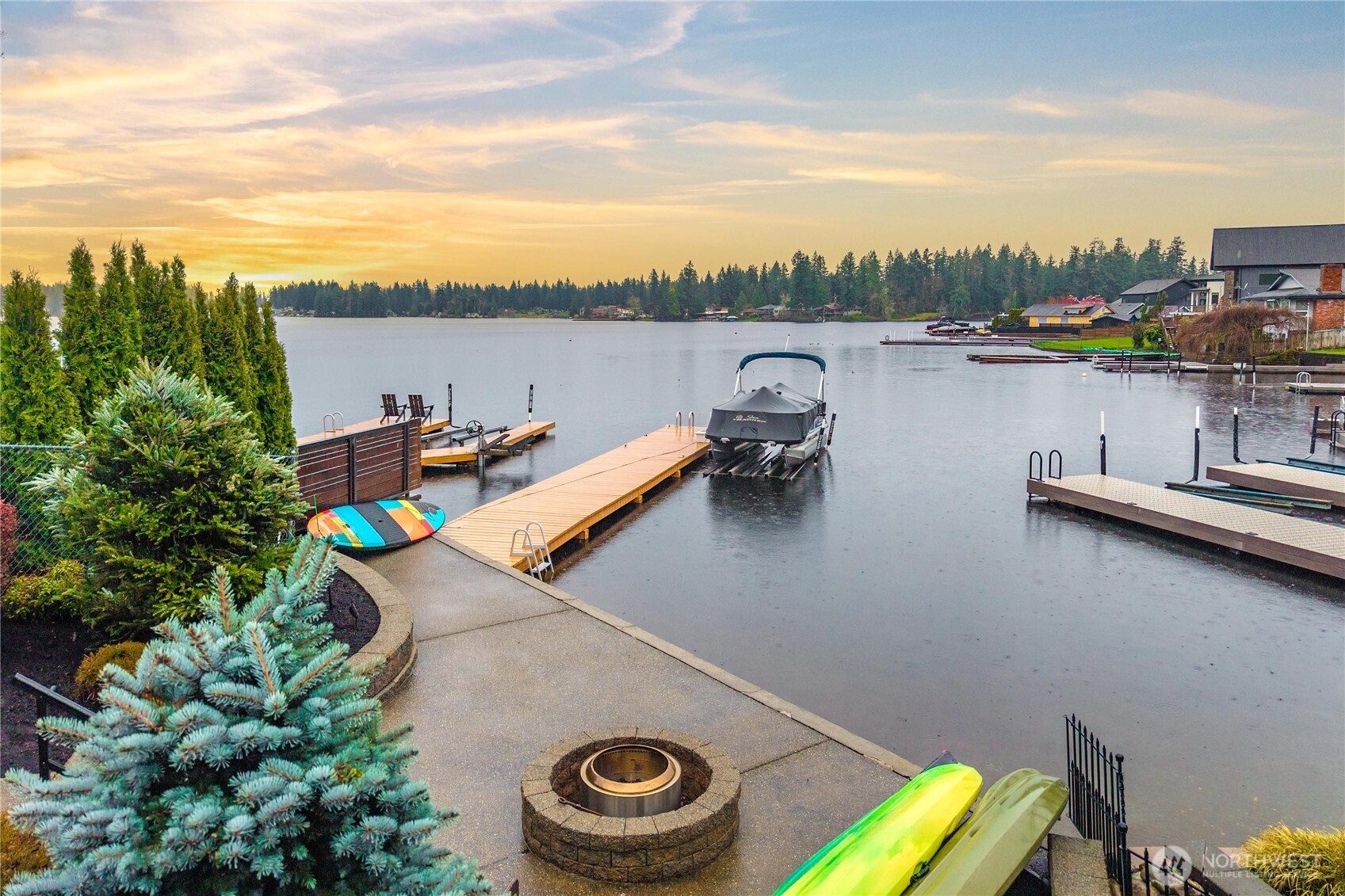 Sun soaked days, sparkling water, and the kind of view that makes everyday life feel like a getaway, this stunning Lake Sawyer waterfront delivers the lifestyle buyers dream about. Set on approximately one third acre with coveted southwestern exposure, this move in ready paradise was designed to celebrate the lake from nearly every angle. The main level offers open living spaces filled with natural light, expansive windows framing the water, and a beautifully remodeled kitchen completed in 2022 with quartz counters and updated finishes. Two main floor bedrooms, an updated bath, and easy flow to outdoor living spaces create flexibility for everyday living and entertaining. Upstairs, the primary suite is privately positioned at the back of the home to fully capture the expansive lake views. This oversized retreat features a large sitting area, ideal for relaxing or converting to a fourth bedroom, along with a beautifully remodeled five piece bath completed in 2024. Additional upgrades include a newer roof with transferable 10 year warranty, retractable awnings, heat pump with A/C, high end TimberTech PVC deck, and new hot tub. Outside, enjoy a dock with boat lift, beautiful low maintenance landscaping, sprinkler system, fire pit area, large front yard, tons of parking, detached garage, and dedicated RV parking. Heated shop area with half bath and mini kitchen offers added flexibility and possible future ADU potential. Tahoma Schools complete this exceptional lakefront setting.