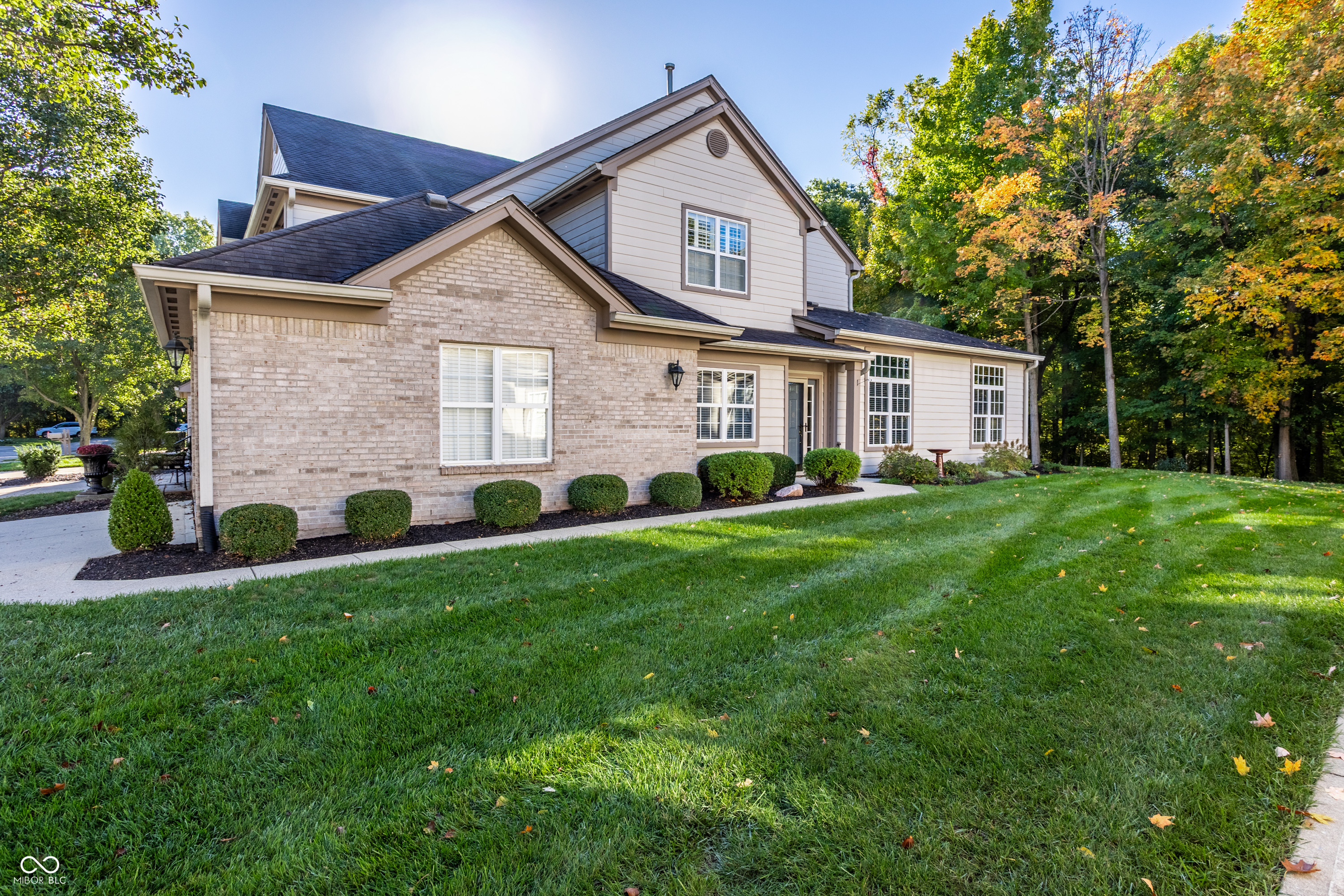 A life of tranquility awaits you at 9275 Muir Lane, Fishers. Located on a quiet street nestled among the woods, this single-story end unit condo provides privacy, peacefulness and convenience. Imagine watching the birds and butterflies come and go through the perennial garden under the windows of the expansive great room. Have a morning coffee in the three seasons room, while enjoying the view of the woods that line the back yard. This home in Muir Woods boasts 1743 square feet of living area, 2 bedrooms with views of the woods, a great room with high ceilings, an office, a kitchen with eating nook, a 3-seasons room, stamped concrete patio, 2-car garage, ample storage, and so much more. Enjoy the access to amenities such as pickleball/tennis courts, a pool, fitness center and community clubhouse. The location in the center of Fishers allows close access to the Nickleplate Trail, Fishers Event Center, Fishers District, IKEA, Meijer, Kroger and Downtown Fishers.  Between the location, the amenities, and the stunning features, there is so much to love about this home. Come visit and see why it is such a beautiful and perfect choice for a future home!