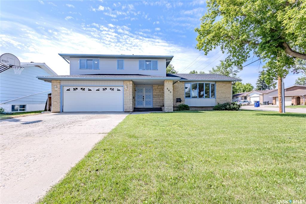Welcome to this beautifully updated family home in Langham, ideally situated on a large lot backing the park and high school, perfect for growing families. Step into a spacious front entry that leads up to a stunningly renovated main floor featuring new laminate flooring and a bright bay window in the living room. The updated kitchen has a black butcher block eat-up island, quartz countertops, under-cabinet lighting, backsplash, stainless steel appliances, and a double undermount sink. A functional walkthrough pantry connects to the rear mudroom with main floor laundry and a convenient two-piece bath. The adjacent dining area offers direct access to the back deck, while a cozy family room with wood-burning fireplace and additional patio doors provides a second main floor gathering space. Upstairs, you'll find three bedrooms with new carpet including a spacious primary suite with a walkthrough closet and a luxurious en-suite featuring a double vanity, freestanding tub, and oversized shower. The partially finished basement includes a fourth bedroom, rec room, storage, and a bonus room perfect for a play area or indoor hockey practice. The large backyard is fully fenced with a gate for RV access, a storage shed, and plenty of room to play. A double attached heated garage completes this fantastic property, ready for your family just in time for the new school year! Contact your Realtor today to schedule a private showing.