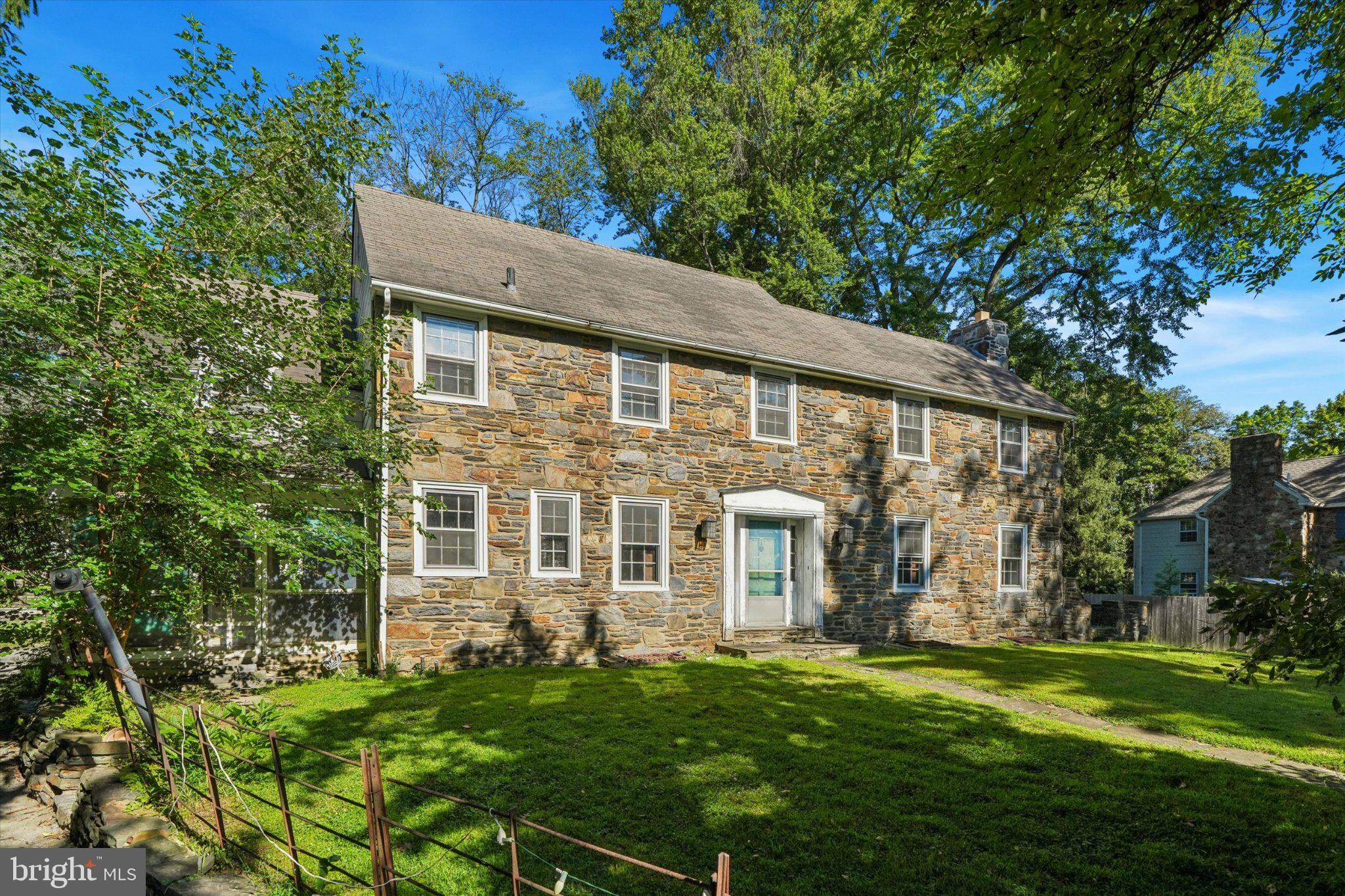 Dreaming of restoring a classic stone colonial home in the heart of Philadelphia’s Main Line? The perfect opportunity to do so on a fabulous almost half acre lot within walking distance to downtown Narberth’s train station and Lower Merion high school awaits. A long driveway provides privacy and parking for 3+ cars off of Montgomery Ave and a garage. Inside the home you’ll find beautiful hardwood floors just waiting to be restored. Envision a thoughtfully redesigned kitchen with a convenient mudroom/laundry room and an open connection to the formal dining room.. A large living room boasts a fireplace and door leading to the patio overlooking the spacious yard with an in-ground pool (needs overhaul or must be filled in). A convenient first floor powder room tucked behind the stairs completes the first floor. Upstairs you’ll find the primary suite with double closets, and access to a shared bathroom connecting through to the second bedroom which could be ideal as a nursery or home office. Two additional good size bedrooms and a hall bath with a tub round out the second floor. The walk-up attic provides abundant storage and exciting potential for future expansion.The unfinished basement offers additional possibilities, with a walkout to the exterior, a plumbed half bath, and laundry facilities.This estate property presents a rare opportunity to restore and reimagine a classic Main Line home in an outstanding location. The property is being offered “as-is”. Buyers will be responsible for obtaining the resale certificate from Lower Merion Township.