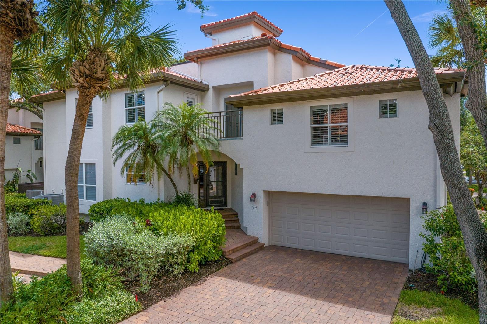 Experience elevated coastal living in this impeccably maintained and beautifully updated Harbour Island end-unit townhome, situated within a community offering 24-hour gated security.  Step inside and you’re instantly greeted by an abundance of natural light and a bright, open layout. The fully remodeled kitchen (2022) is the centerpiece of the home-featuring sleek new appliances, a built-in wine refrigerator, a huge center island and abundant cabinetry that offers exceptional storage. Ideal for entertaining, the space opens effortlessly into the main living area with upgraded sliding glass doors (2022) that open to a private deck – perfect for indoor-outdoor living. The expanded back deck (2020) with built-in bench seating and plush cushions, makes backyard entertaining effortless. 
Throughout the home, wood floors add warmth and continuity to every room. The spacious primary suite features a custom-designed oversized closet, offering both elegance and utility. All bedroom closets have been fitted with professional organizers to maximize space and minimize clutter. Enjoy not one but two versatile lofts – perfect for a home office, creative studio, fitness zone, or a cozy den. Whether you’re working remotely or recharging, these spaces flex to fit your lifestyle. Top of the line upgrades include a central vacuum system (2019), whole-house water softener + filtration system, brand new Lenox A/C with built-in dehumidifier (2025) and an additional AprilAire system upstairs (2021). The home also features a large private driveway, a 2-car garage with vinyl floor rolls for easy cleaning and a Tesla charger. Both the third-floor balcony and rooftop deck were fully redone in 2023 for worry-free enjoyment. Toast to the sunset as cruise ships glide by – your private rooftop deck offers panoramic views and peaceful moments above it all. Nestled in a prime, highly sought-after area, this property offers effortless access to Tampa’s thriving downtown scene. You’re a short stroll away from Water Street, Amalie Arena, Sparkman Wharf, Channelside, Lifetime Fitness and the Riverwalk where you will find great restaurants, coffee shops, and weekend farmers’ markets. Harbour Homes is a beautifully maintained and landscaped neighborhood with tree-lined streets and a large neighborhood pool. Harbour Island offers a lifestyle that’s both luxurious and livable. This turn-key residence is an incredible opportunity for anyone seeking elevated living in the heart of Tampa. Don’t miss your chance to own a home where thoughtful upgrades, stunning details and prime location come together seamlessly.