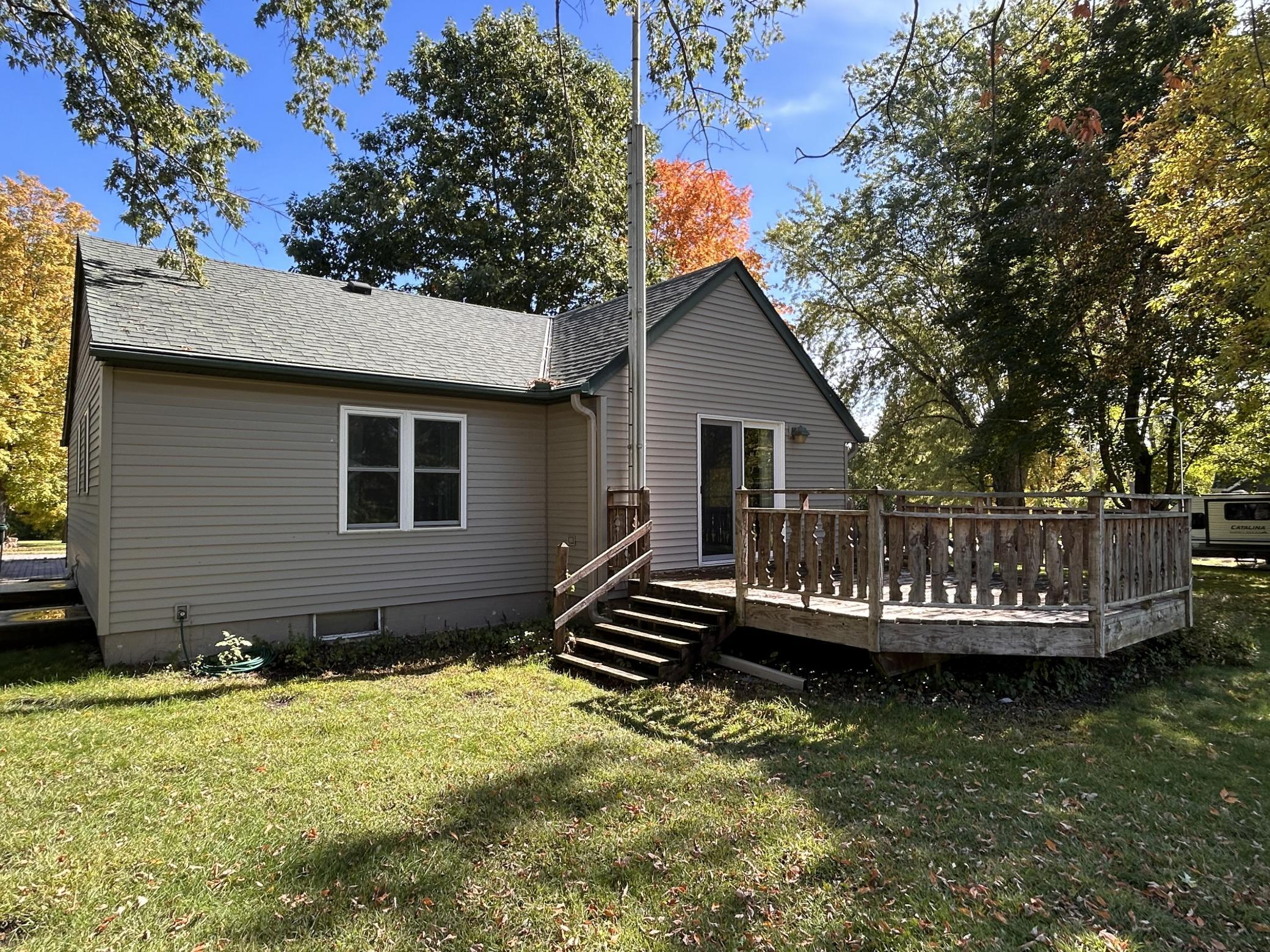 Rare opportunity featuring a 2-bedroom, 1-bathroom home on over 1 acre of property close to town conveniences! The main level offers convenient main floor laundry, while outdoor spaces include a patio and deck. Plus, enjoy incredible outbuildings: a 35'x21' detached garage (with a 24'x21' garage space and 17'x10' enclosed workshop) and historical outbuildings originally used as a chicken hatchery. Includes a 100'x40' shed with a front 36'x19' workshop, dual storage rooms, and a 9'x8' rear garage door, as well as a second 67'x33' shed with 10'x8' and 9'x7' overhead doors. Endless storage, hobby, and workshop potential!