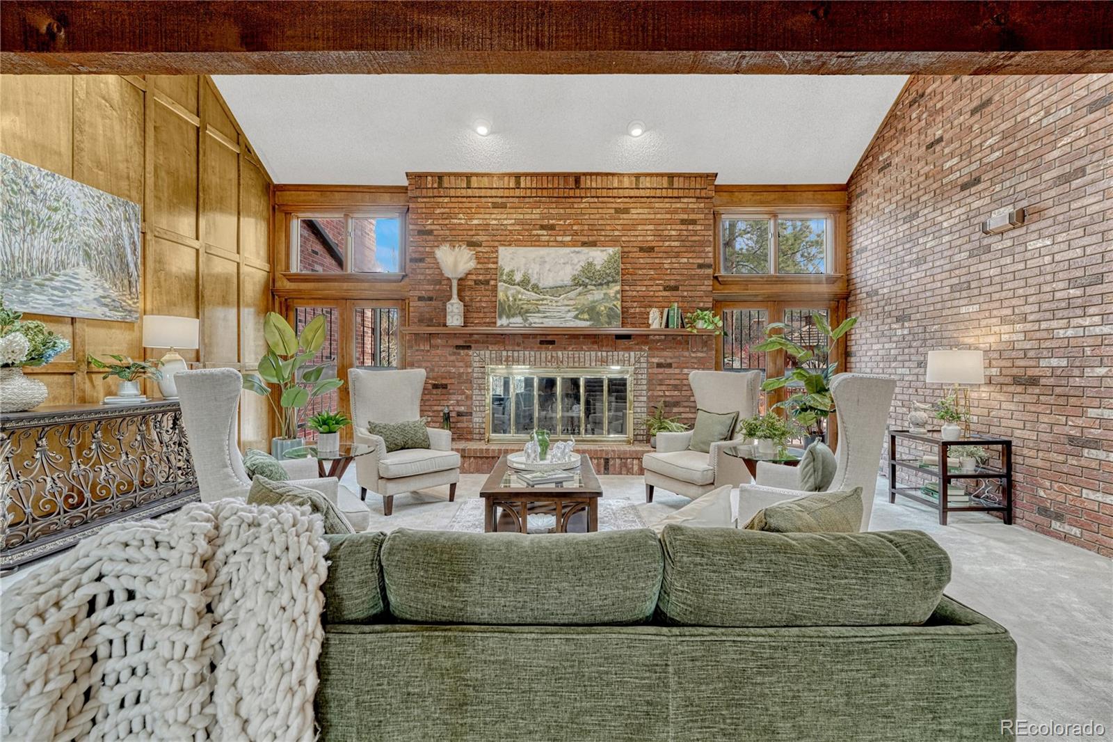 TIMELESS TUDOR tucked at the end of a quiet cul-de-sac on just under an acre in highly desirable Greenwood Village. Enjoy mountain views on nearly 9,500 square feet of classic architecture offering scale and exceptional entertaining potential. Six generously sized bedrooms, all with ensuite baths and a split floor plan providing separation throughout. Primary suite options on both the main and upper levels offer flexibility ideal for multigenerational living. Rich wood beam ceilings, traditional wood detailing, and a striking copper turret highlight the enduring craftsmanship rarely found today. ENTERTAINING SPACES: Designed for gathering indoors and out with multiple living areas, front courtyard, and an oversized back paver patio ready for hosting and events. All surrounded by mature landscaping, gardens and water features. KITCHEN: Custom brick hood over the cooktop, center island, and eat-in area with direct access to the formal dining room. MAIN FLOOR: Spacious family room with wet bar, two half baths, primary and secondary bedroom suites and seamless flow to outdoor spaces. UPSTAIRS: Light filled loft retreat ideal for relaxing or unwinding. Private primary suite with French doors, fireplace, walk-in closets, and ensuite bath with an additional fireplace. Also, a secondary ensuite flexible as a bedroom or office with adjacent conference style space or closet, steam shower, and sauna. FINISHED BASEMENT: Two additional bedroom ensuites, large family room with wet bar, wine cellar, and a bonus room ideal for fitness, media, or hobby use. HOME EXTRAS: Recent $200k exterior improvements including a 50-year stone coated steel roof, new gutters, stucco replacement, and exterior paint. New dishwasher. 3 car garage with 220 outlet. Dual zoned HVAC. Seven fireplaces. Extensive storage. No HOA. West facing front yard allows for easy snowmelt. Architectural presence and scale invite thoughtful updates for a discerning buyer who values space, privacy, and timeless design.