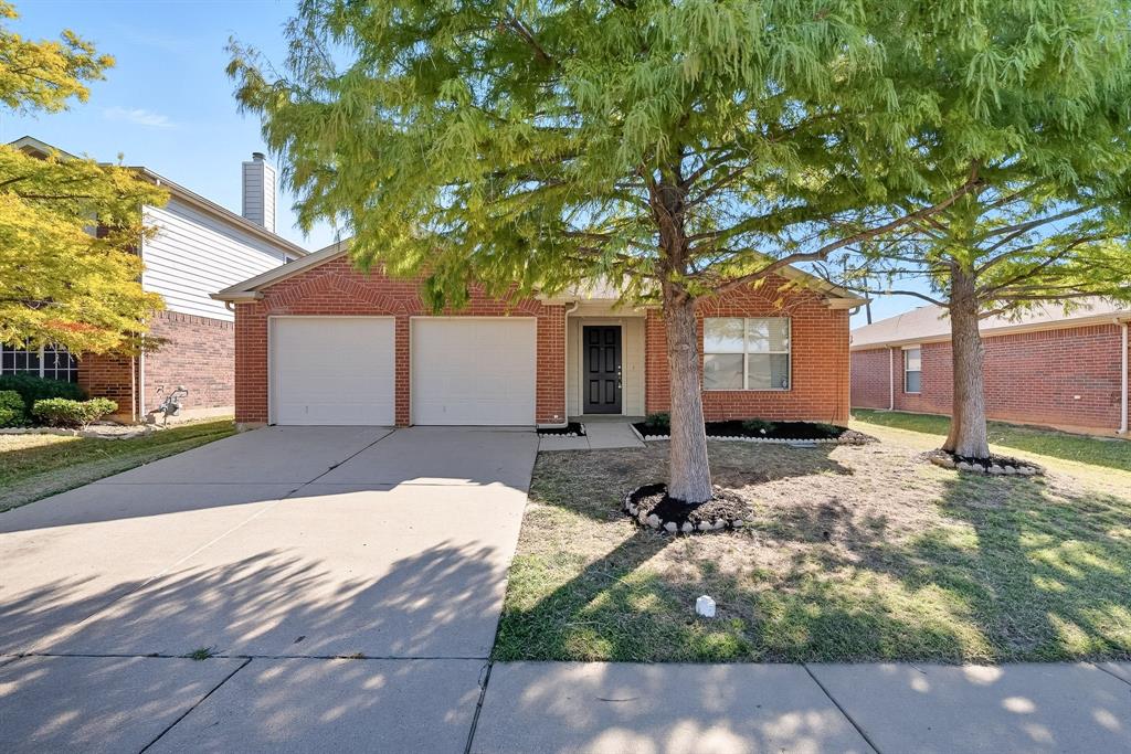 This single-story home offers 3 bedrooms and 2 bathrooms with a 2-car garage and a spacious, wood-fenced backyard. The open floor plan seamlessly connects the living and dining areas, highlighted by a cozy fireplace and a kitchen island with a pantry. The primary suite features a separate tub and shower, plus a double vanity. One or more photos have been virtually staged to showcase the home’s potential.