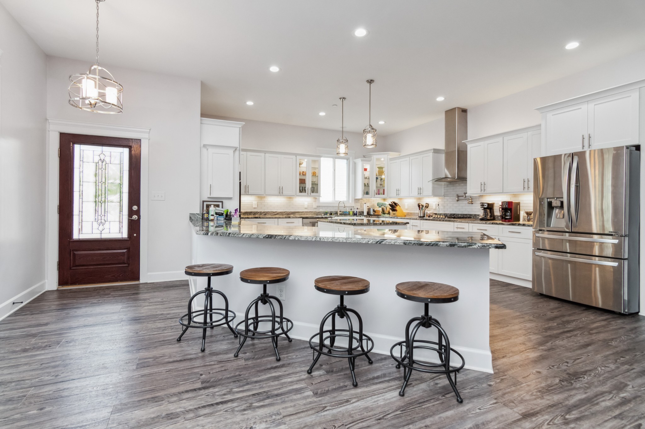 Top Quality Custom Home:  Way too much to mention all, but here are a few of the upgrades. The home has been freshly painted and sparkling like new. The kitchen is a dream-come-true. Exquisite granite (grade A) with large island.  Double ovens (one convection), gas range with pot filler. Large pantry. 10 foot ceilings. 2 primary bedrooms on main level. Custom tiled shower.  Barn door to office.  2 bedrooms upstairs with a large bathroom. This home has over 3900sq feet with the potential of being 5000 sq ft if the 1100 square feet of unfinished space on 3rd floor was finished. The 3rd level is already insulated with roughed-in plumbing and electricity that sits over the 3 car garage.There is also a flat roof between the main home and the garage that would make for a fantastic patio!    Plantation shutters and wood blinds.  Gas tankless hot water system.  2 HVAC units; one gas and one electric. Double lot with fenced side yard.  Walking distance to restaurants, brewery, chiropractor, attorney, etc.  Small park with basketball court across the street.  This community is a life style of its own.