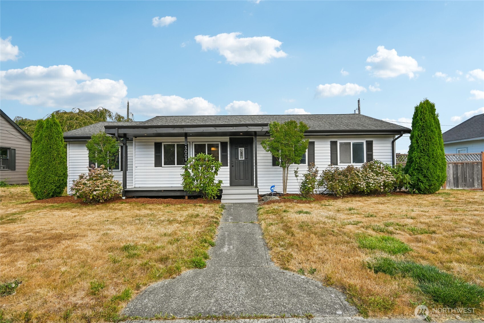 Discover this inviting Tacoma rambler offering 3 bedrooms, 2 bathrooms, and a flexible den that provides the option for additional sleeping space, an office, or whatever suits your needs. The spacious kitchen is designed for everyday living with an island, abundant storage, and room for a dining table. A separate dining area and welcoming living room create a comfortable layout for both entertaining and relaxing. The primary bedroom features its own private bathroom and walk-in closet. Step outside to a sizable deck and generous yard with plenty of room to enjoy the fresh air. The detached garage and driveway offer convenient off-street parking. With shopping, restaurants, schools, transit, Highway 7, and I-5 all nearby, this home offers both comfort and convenience.