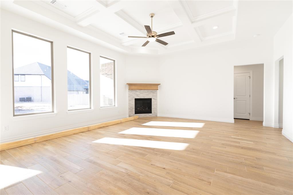 The Hazel floor plan has a total of 2,095 Sqft for living space, including 1,900 Sqft of indoor living and 220 Sqft of outdoor living that features a wood-burning fireplace, a gas line, and a TV hookup! This immaculate home offers 4 bedrooms, 2 full bathrooms, covered patios, a utility room, and a 3-car garage with an in-ground storm shelter installed. The great room presents a beautiful coffered ceiling with a ceiling fan, a gorgeous corner gas fireplace with our stacked stone detail, large 7’ windows, rocker switches throughout, and elegant wood-look tile. The high-end kitchen has stainless-steel appliances, including a 5-burner cooktop, decorative tile backsplash, custom-built cabinets to the ceiling with under cabinet lighting and cabinet hardware installed throughout, a large corner pantry, 3 CM countertops, more wood look tile, stunning pendant lighting, and an oversized center island that holds a spacious sink, a dishwasher, and a trash can pullout. The primary suite spotlights a sloped ceiling detail with a ceiling fan, windows, and our cozy carpet finish. The spa-like prime bath has a free-standing tub, a dual sink vanity with framed mirrors, 3 CM countertops, a European walk-in shower, a private water closet, and a huge walk-in closet with horizontal and vertical storage opportunities. Secondary bedrooms feature high ceilings with ceiling fans, sizeable closets, windows, and carpeted flooring. Other amenities for this energy efficient home include a tankless water heater, a fresh air ventilation system, R-44 and R-15 insulation, and so much MORE!