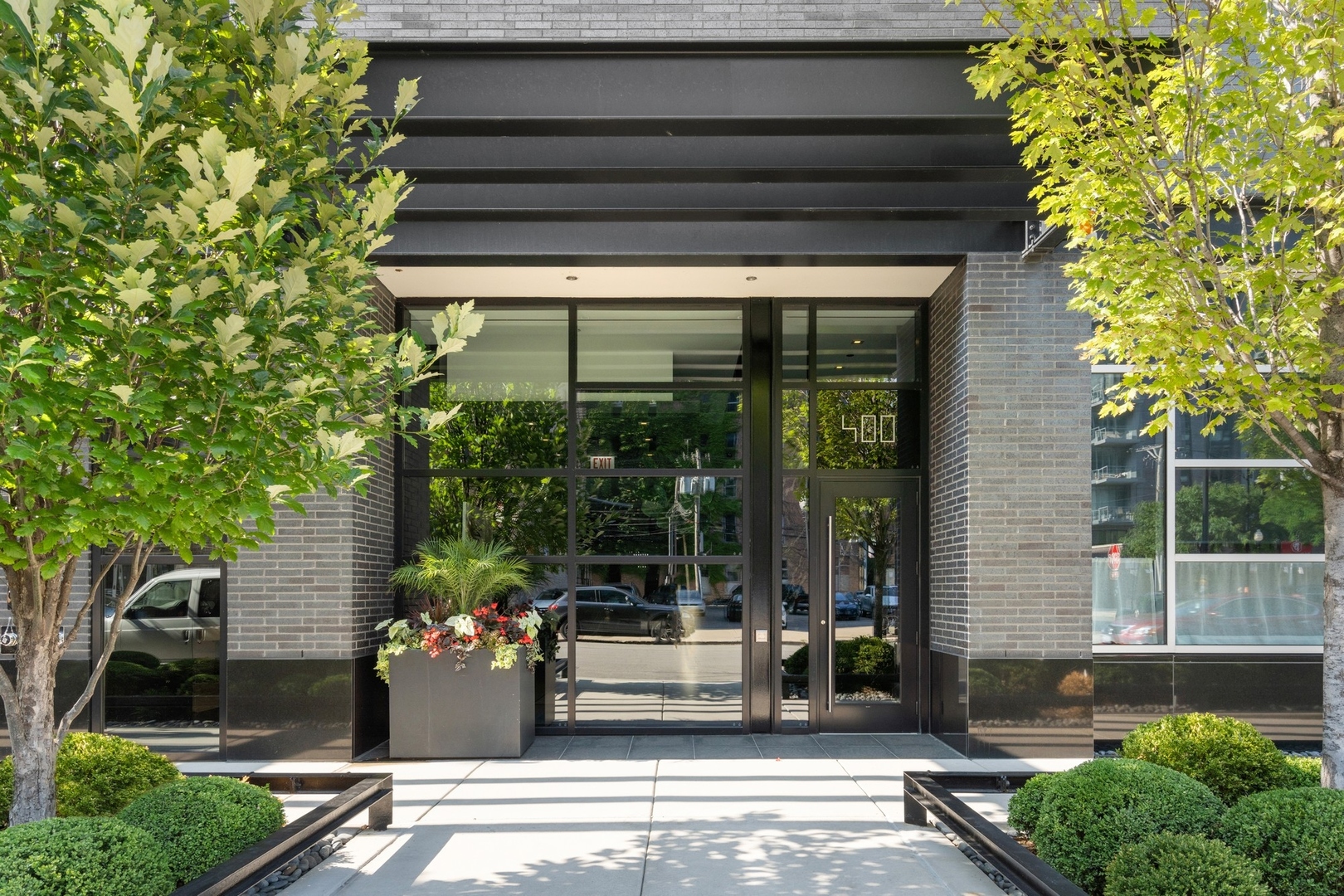 Design-forward and contemporary with flawless fixtures and finishes throughout, 400 W. Huron St., unit 801, is a 3,065-square-foot, 3 bed/3 bath luxury condo in the heart of River North with an impressive indoor-outdoor footprint. Located on a posh stretch of Huron, close to lifestyle amenities at BIAN and East Bank Club, this professionally designed home begins with an open foyer that features high ceilings, Venetian plasterwork, dark gray slate flooring, and an adjacent, custom-designed coat closet that links to a bonus, walk-in storage room. Via an interior gallery hall that affords access to a jewel box powder room with a hand-painted wallcovering by de Gournay, the entry also connects to a natural-light-filled, 20' x 36' great room that encompasses a trio of elevated spaces for entertaining and everyday living: a grand living room, a corner-positioned dining room, and a modern chef's kitchen. The living room boasts beautiful, built-in bookshelves including a custom magazine rack and floor-to-ceiling windows that frame spectacular skyline views. The dining room delights with a Parisian pendant light and space for a 10-person table. The beautifully appointed, custom kitchen features seamless Italian cabinetry, white quartzite countertops, Miele appliances including a double oven, a large island that seats four, and a built-in bar with floating glass shelves. Better still, the kitchen and dining room connect to an incredible 9' x 46' terrace with an abundance of space for outdoor dining, lounging and grilling. Both of this home's secondary bedrooms are exquisitely designed and offer access to full baths with polish and personality. (One of the two secondary bedrooms is currently styled as a fashionable library with a custom media center with shelving and cabinetry, but the room can easily be transitioned back to a bedroom based on preference.) There's also a tucked-away home office with a built-in, L-shaped desk for working from home. On the opposite side of the floor plan, this home presents a spectacular primary suite that begins with a long hallway with more built-in custom storage (both cabinets and drawers) that's followed by a corner bedroom with two full walls of windows, a seating area, decorative eglomise (gilded glass) wall panels, a custom 11' x 17' dressing room with styling island, and a spa-like marble ensuite bath with dual vanity, soaking tub, a deluxe shower, and a separate water closet. Callout details include custom millwork, paint, and wallcoverings throughout, designer lighting and window treatments, high-end custom finishes and plasters by Simes Studios, handmade laser-cut light panels, state-of-the-art AV, and full home automation including electric shades and mood lighting. Building amenities include an incredibly chic lobby with door staff, a fitness center, a dog run, private wine lockers, and two garage parking spaces. (Pets allowed.) Steps to James Beard Award-winning restaurant Obelix, blocks from the Chicago River and the Design District, and minutes from the world-class shopping, dining and culture that surround the Mag Mile, 400 W. Huron St., unit 801, is one-of-a-kind luxury living with total privacy, turnkey comforts, and high style.