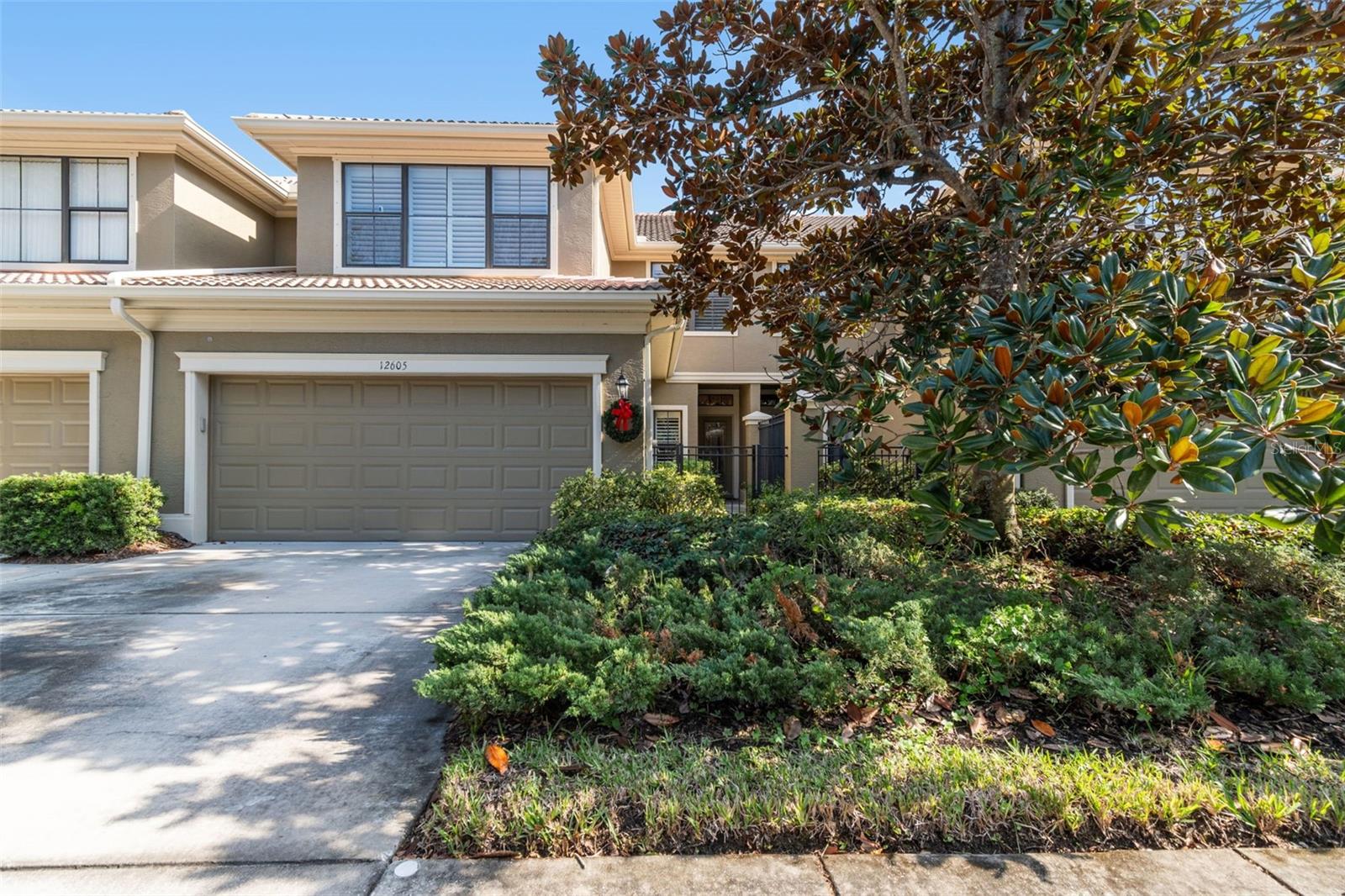 Welcome to this stunning 2007-built townhome in the desirable Beacon Trace community, offering the perfect blend of luxury, convenience, and low-maintenance living with block construction and tile roof. This spacious residence features a beautifully landscaped courtyard entrance,  3 bedrooms and 3.5 bathrooms, complete with an attached 2-car garage. The highly sought-after floor plan places the secluded Primary Suite on the main floor and en-suite with large walk in closet, separate soaking tub and shower and dual vanity.  The upstairs boasts a Secondary Suite, an additional guest bedroom, and a large, versatile loft area, making it ideal for guests, an office, or an entertainment zone. Step out onto your private, screened lanai and enjoy the tranquil view of the pond framed by luscious, mature landscaping. Additional premium perks include Plantation Shutters throughout, a generator for peace of mind, a convenient inside laundry room, Custom hurricane panels stored in the garage and a water softener system.  The HOA covers exterior maintenance, insurance, roof reserves, and pest control.  The convenient location is close to the Gulf Beaches, shopping, restaurants, the Southwest Rec Center and Largo Golf Course.  This home is an absolute must-see for those seeking a stylish, comfortable, and well-equipped lifestyle in a fantastic location!