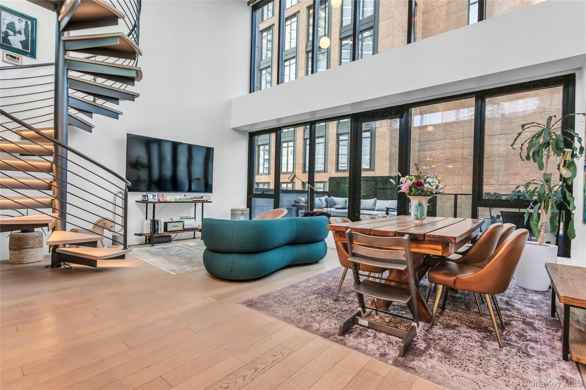 Penthouse with Nearly 1,500 SF of Private Outdoor Space in Long Island CityPerched at the top of the building, this exceptional three-bedroom, three-bathroom penthouse offers a rare combination of refined interiors and nearly 1,500 square feet of private outdoor space—an offering seldom found in Long Island City. Spanning approximately 1,635 square feet, the residence is defined by soaring ceilings, floor-to-ceiling windows, and a seamless indoor-outdoor layout.The home opens into a dramatic living and dining area with striking double-height ceilings and bright southern exposure. Designed for both everyday living and entertaining, the space flows directly onto a large private terrace ideal for outdoor dining and gatherings.The open kitchen is designed with both function and entertaining in mind, anchored by a substantial eat-in island offering expansive counter space. Custom cabinetry is complemented by sleek stone countertops and backsplash, and a full suite of ultra high-end, penthouse-level appliances completes the space.A sculptural spiral staircase leads to a second expansive rooftop terrace, creating two distinct outdoor spaces for entertaining, relaxing, or simply enjoying open views. Together, the terraces offer a level of flexibility and lifestyle rarely available in condominium living.The primary suite and additional bedrooms are generously proportioned, each offering excellent closet space and well-appointed bathrooms with high-end finishes and radiant heated floors.What truly sets this residence apart is the scale and usability of its outdoor space—surpassing the size of the vast majority of New York City apartments and offering a truly unique opportunity for expansive private outdoor living.Residents enjoy a full suite of amenities including a well-equipped fitness center with open views, along with a thoughtfully designed resident lounge and adjacent children’s playroom that offer flexibility for both work and relaxation. As one of only two residences on the penthouse level, PHA benefits from a unique sense of privacy, with the fitness center, resident lounge, and children’s playroom all located on the same level—creating a seamless extension of the home.Situated in the heart of Court Square, the location offers immediate access to multiple subway lines (7, E, M, G), making travel to Manhattan, Brooklyn, and beyond exceptionally convenient. Everyday essentials such as Trader Joe’s and Food Cellar are just moments away, along with a growing collection of restaurants, cafés, and neighborhood favorites throughout Long Island City. Court Square has quickly become one of the most convenient and connected neighborhoods in Western Queens, with nearby cultural institutions including MoMA PS1, SculptureCenter, and Culture Lab LIC, as well as parks, waterfront access, and recreational options such as Gantry Plaza State Park and Movement LIC.