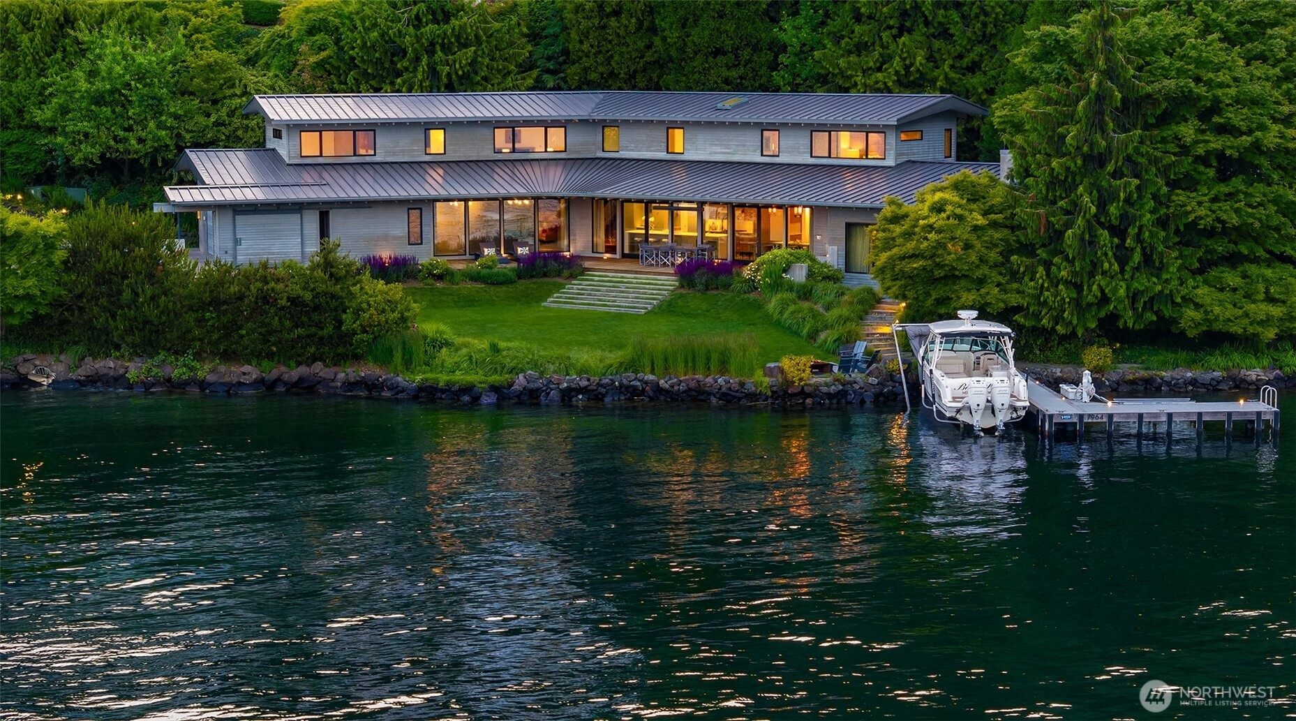 A flawless architectural masterpiece by SKB Architects, brilliantly blending natural elements with indoor-outdoor living. This home offers an unmatched modern living experience, with a masterful design that optimizes this expansive ½-acre level lot. With 168' of no-bank waterfront, deep-water moorage, and a private dock, it offers the ultimate waterfront lifestyle. Floor-to-ceiling windows frame sweeping, serene views of Lake Washington and Mt. Rainier, creating a tranquil ambiance. A wide IPE deck w/ large overhangs & space heaters, and an expansive lawn that leads directly to the water’s edge, enhance the outdoor experience. Designed and constructed to the highest standards, this exceptional property is a rare opportunity and a must-see.