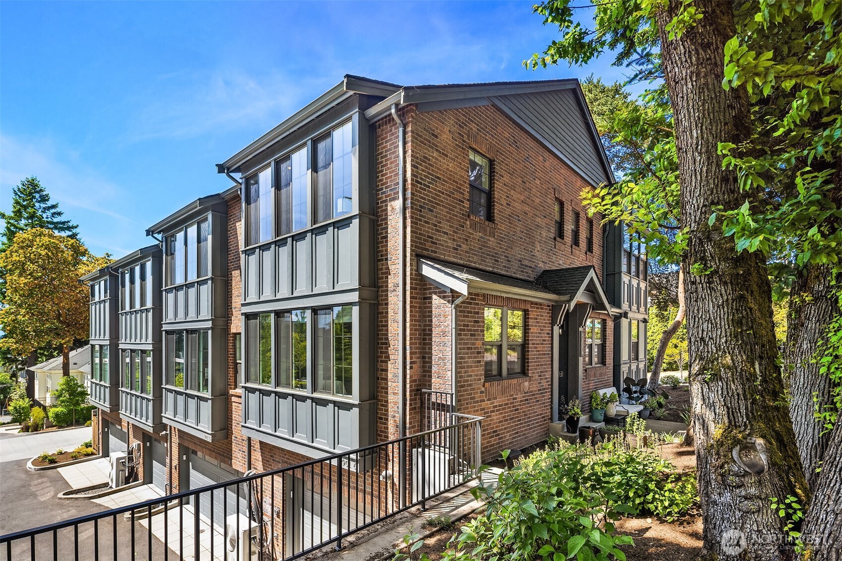 Classic brick grandeur townhome is located in one of Seattle’s most coveted neighborhoods. This Queen Anne corner lot smart home has sun-drenched open living spaces with hardwood floors. Designer finishes frame a chef’s kitchen for elegant or casual dining. Kitchen was created to showcase your culinary skills with top-of-the-line appliances which includes a Thermador gas range, Sub-Zero refrigerator, granite countertops and custom pantry. Spacious dining room and living room with gas fireplace and lots of natural light for ultimate entertaining. Unwind in private primary suite with views of the Sound.  Two additional bedrooms ensuites are nice and comfortable. Lots of storage and attached 1-car attached garage. Mini-splits provide year-round comfort for heating and cooling. HOA covers all exterior maintenance. Live where comfort meets style—close to the best of Queen Anne living. Minutes to Macrina’s Bakery, Farmer's Market, parks, shops & more. Refined living in the heart of it all.