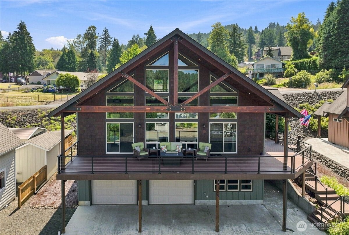 Located within Lake Mayfield Village, this custom home offers beautiful lake and territorial views, quality construction, and year-round recreation. Features include quartz countertops, solid-core doors, distinctive reclaimed whiskey barrel hardwood floors, and a heat pump for year-round comfort. A spacious loft and bonus/flex room provide additional space for sleeping, working, or relaxing. RV parking with full hookups adds convenience.  The expansive composite deck is ideal for relaxing and entertaining while enjoying the views. The deep tucked-under garage is insulated and finished with insulated garage doors, offering plenty of room for boats, kayaks, ATVs, bikes, and other recreational gear.  Enjoy easy access to a marina and boat launch for boating and fishing, plus hiking at Mt. Rainier and Mt. St. Helens. In winter, White Pass Ski Area, approximately 70 miles east, offers downhill skiing, snowboarding, and Nordic trails.  A great opportunity for a weekend retreat, vacation home, or year-round getaway with easy access to four-season recreation.
