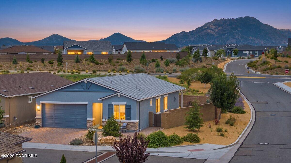 This beautifully maintained home truly feels like new! Lovingly cared for by part-time owners and rarely occupied, it offers a wonderful combination of thoughtful design, quality upgrades, and effortless living.Designed to showcase the breathtaking views of Granite Mountain, the spacious living area features expansive glass sliders that open to a generous covered patio--creating the perfect setting for relaxing, entertaining, or simply enjoying the scenery.The gourmet kitchen is a standout, featuring warm cabinetry, beautiful appliances, granite countertops, and a striking copper backsplash. Convenient pull-out drawers make accessing pots and pans a breeze, while under-cabinet lighting provides both ambiance and additional outlets, cleverly tucked away for a clean, uncluttered look.The spacious guest bedrooms are thoughtfully positioned at the front of the home, offering privacy from the primary suite. The primary retreat provides plenty of room to unwind, while the beautifully appointed bath features a large walk-in shower and excellent closet space.Just off the front hallway, the versatile bonus room can easily serve as a home office, den, hobby room, or additional living space. It could even be enclosed to create a more private room to suit your needs. Every detail was chosen with comfort, efficiency, and convenience in mind. Beautiful luxury vinyl flooring and ceramic tile provide durability and easy maintenance, while energy-efficient appliances and systems help make everyday living more economical.Numerous upgrades were incorporated during the build, including a 16 SEER HVAC system, solar blinds in the living areas, and blackout blinds in the bedrooms.This exceptional home combines like-new condition, thoughtful design, quality finishes, and spectacular mountain views. You truly must see it in person to appreciate all it has to offer!