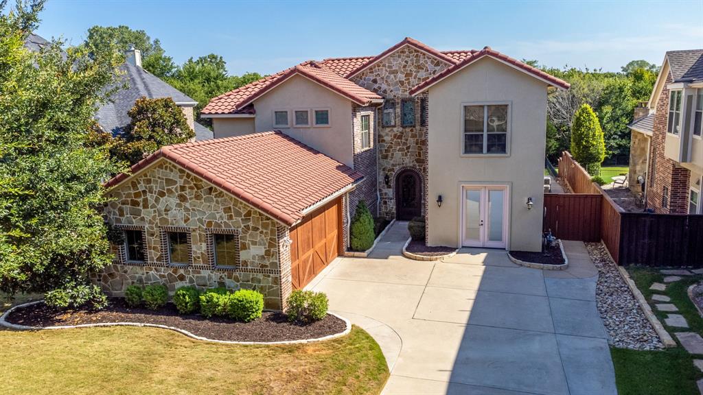 Price reduction! Welcome to your custom-built Mediterranean style home. Step through the Beautiful Cantera steel door and view 20ft ceilings in the formal living room with fireplace and surround sound system, large windows with a spectacular view of the patio with fireplace and pool, 5 bedrooms (Master and guest on main floor) Large Master Suite overlooking the private back yard. (3 upstairs-all with spacious closets) 4 full baths (2 full up-2 full down) Downstairs enjoy the custom built media room includes (Snell built-in wall speakers, 110 inch screen, Pioneer Receiver and 3D projector) with dry bar . Custom Kitchen with Nutty Alder wood cabinetry and travertine and hardwood flooring throughout and all new appliances. Eat in while overlooking the travertine decking with heated pool, enjoy family playing a game of basketball or Pickle Ball on the custom-built court in your private Oasis. Meeting the neighbors while enjoying a long walk or run using Wilson Creek Trail with direct access to Bonnie Wenk Park's 10 mile Trail, 5 Acre Fishing Lake with Dog Park Loop and Fitness Court.