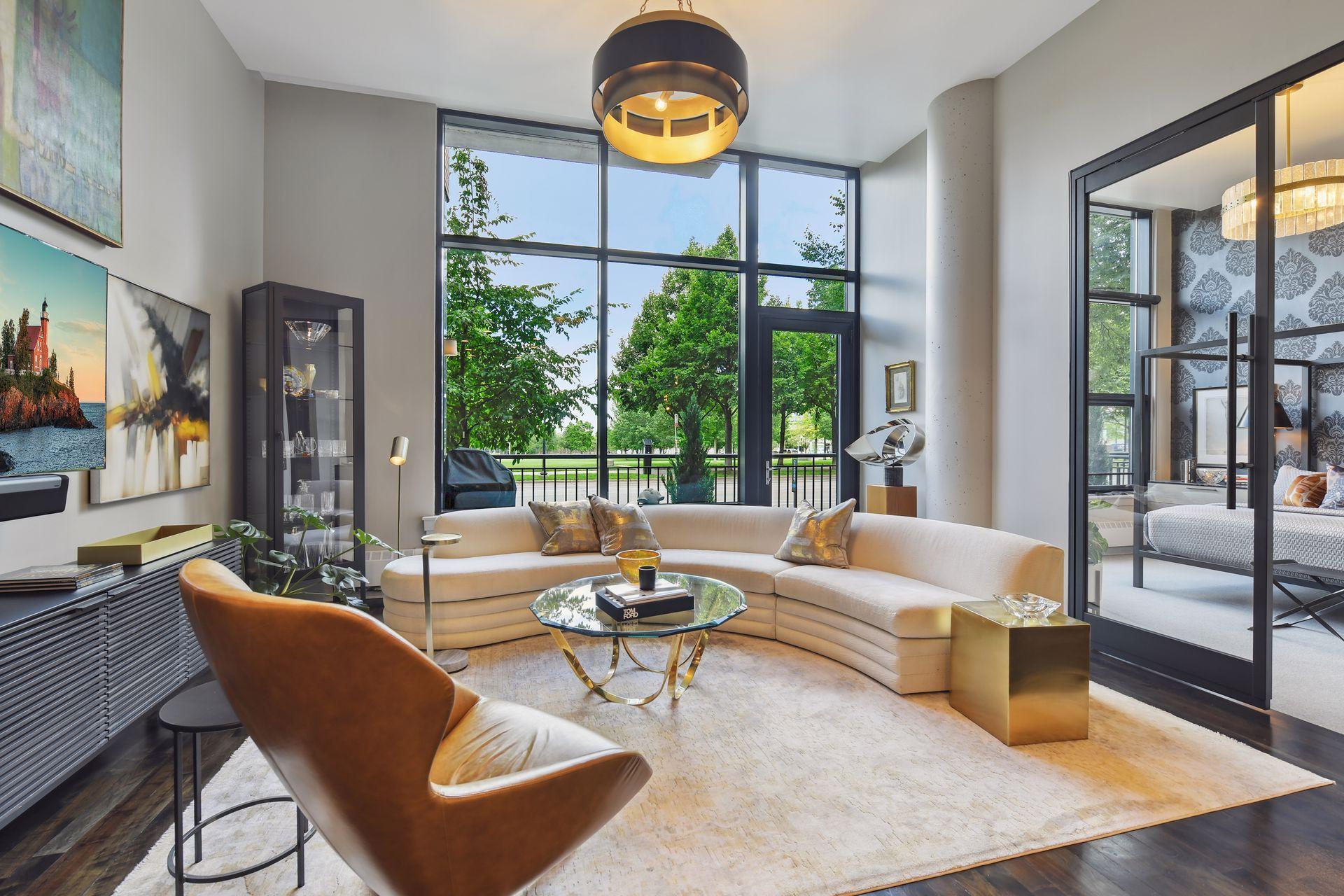 One-of-a-Kind, beautifully styled and professionally designed, condo facing Gold Medal Park. Updates include custom 9.5’ glass/steel French doors. 8.5’ glass/steel sliding doors, kitchen soffit with recessed lighting, all new lighting throughout, refinished walnut floors, new wool carpet throughout, all new paint and wallcoverings. Features include 13.5” foot ceilings with expansive views of the park, private terrace with gas hook-up, located on first floor with easy access to elevators, storage locker and recycling. Garage stalls include bike rack and additional storage cabinet. Enjoy the roof-top pool, fitness center and huge 2-story community room with views of US Bank Stadium. Walk to Guthrie, Gold Medal Park, Stone Arch Bridge, and Farmer’s Market.
