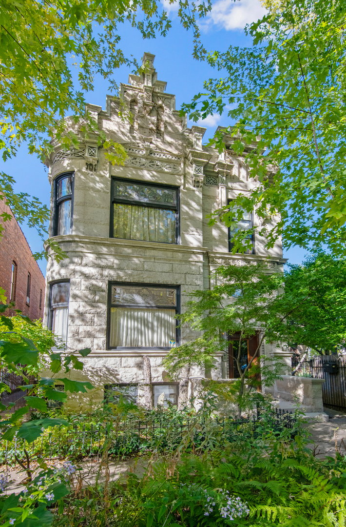 Once in a lifetime opportunity to own a true urban oasis with a majestic renovated greystone on a 104'x126' vast city compound with a charming coach house overlooking a picturesque garden in the desirable Bucktown neighborhood. This breathtaking dwelling was meticulously restored to celebrate the original fretwork, cove moldings, oval leaded glass windows, ceiling medallions, oak fireplaces with antique mantels, original tiles, and oak mirror in the entryway. The modern steel and glass additions of a jaw dropping solarium off the side of the home, the glass rear staircase (fabricated by the company that made the famous "Bean" in Millennium Park), and the sleek chef's kitchen are a masterclass in juxtaposition to the intricate original details showcasing the history of this 1896 abode which was brought into the 21st century. Greeted by a stately exterior with relief carvings and gas lamps, a gracious foyer welcomes you into a sunny double parlor living room with original pocket doors separating the formal dining room which boasts a double sided original hutch with curved beveled glass and a custom chandelier by artist Lucy Slivinski made from a tree on the property. Legitimate chef's kitchen with commercial grade appliances, unique natural stone countertops, pizza oven, room for a large table, and fresh produce from the property's variety of fruit trees, vegetable garden, and delicious honey from the bee hives on the rare urban rooftop garden. The heart of the home is the extraordinary glass atrium solarium off of the kitchen which transports you from an urban environment to being immersed in nature with an indoor koi pond and a remarkable backdrop of blooming scenic landscaping. The staircase up to the 2nd level features a wood paneled art gallery to hang your favorites with picture molding. Original fretwork has been meticulously restored and repositioned on this level to find awe-inspiring 19th century craftsmanship at every turn. Beautiful 2nd floor family room with original display shelving cabinet to anchor the room. Large primary suite boasts pendants which are works of art made from silk chrysalises, a large sitting room with curved glass windows and original fireplace, custom-built-ins, large walk-in closet with custom built oval jewelry cabinet, and a zen inspired bathroom with stunning natural stone oversized shower, and antique fixtures such as a Chinese soaking tub, vanity, pendants and door for a tranquil spa-like experience. Two-more bedrooms with a shared en-suite bathroom complete the 2nd level. The lower level features radiant heated flooring, 2 additional bedrooms, a full bathroom with steam shower, laundry, a dog wash station, and abundant storage. There is an extra 2BR/2BA apartment on the basement level with its own entrance and a kitchen with high end Sub Zero, Wolf, and Miele appliances ideal for au-pair or in-law suite. The home is equipped with an elevator which goes all the way to the rooftop level (this renders the house fully wheelchair accessible) for a special walk through a "garden in the sky" professionally landscaped by Intrinsic landscaping with a drip irrigation system with native perennials and bee hives producing the most delicious diverse honey. The rear of the home has a doggie door leading to a smaller fenced in dog yard, a firepit, a large patio with an amazing Zanzibar door as the backdrop on the 2.5 car garage. Parking pad on the side of the charming 1874 coach house known to house celebrities filming in Chicago. This beloved coach house was picked up from behind the house next door and moved to its current location with the vast front yard and features original pine floors, wood burning fireplace, updated kitchen with Carrera Marble countertops, 2 bedrooms, 2 renovated bathrooms, and a lower level family room with another Zanzibar door. The magical yard is filled with intoxicating blooms from Magnolia trees, and includes apple trees, peach trees, raspberries, and gooseberries.